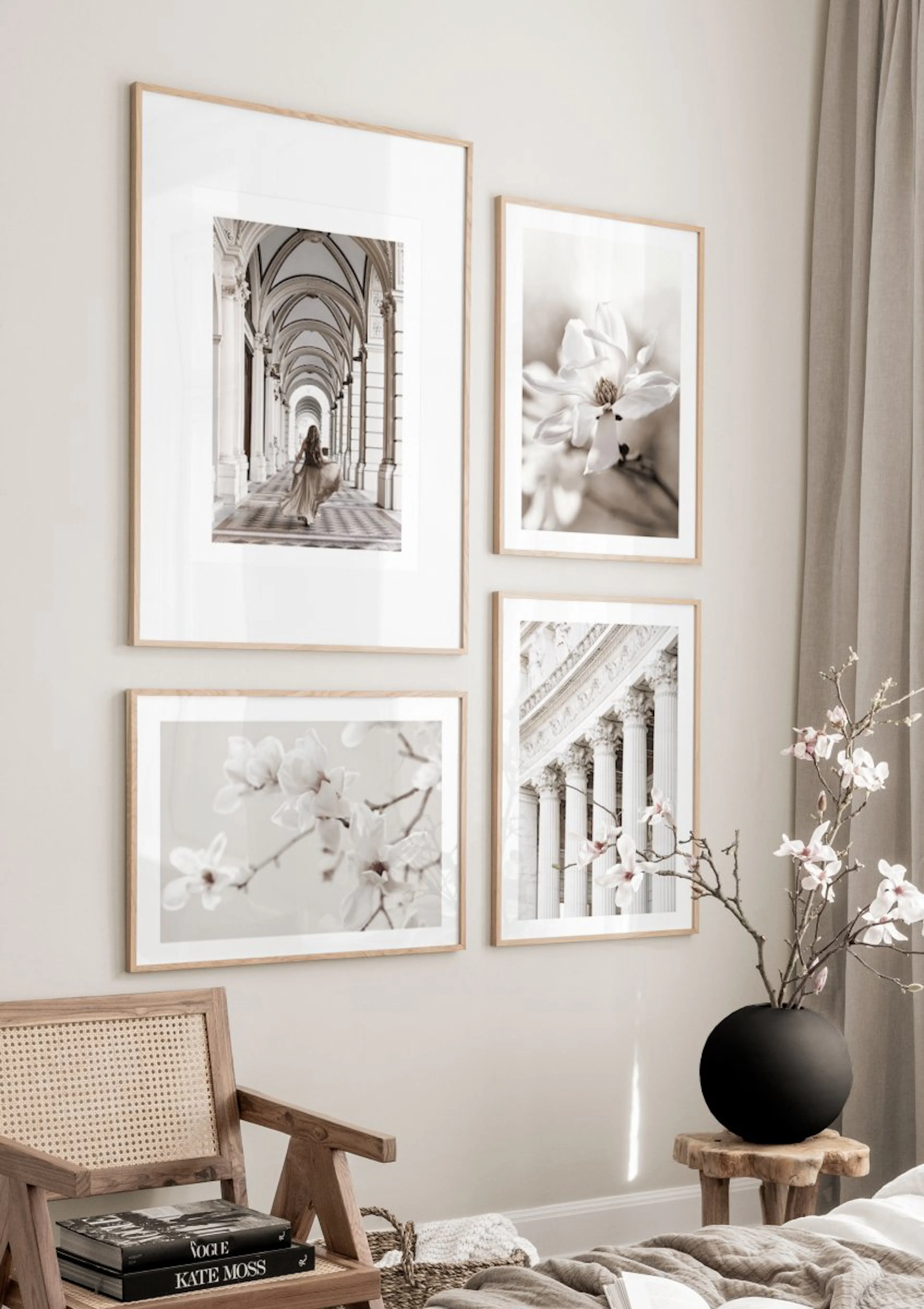 A gallery wall with four posters including a woman in an arched walkway, magnolia blossoms, and classical columns, in a bedroom.
