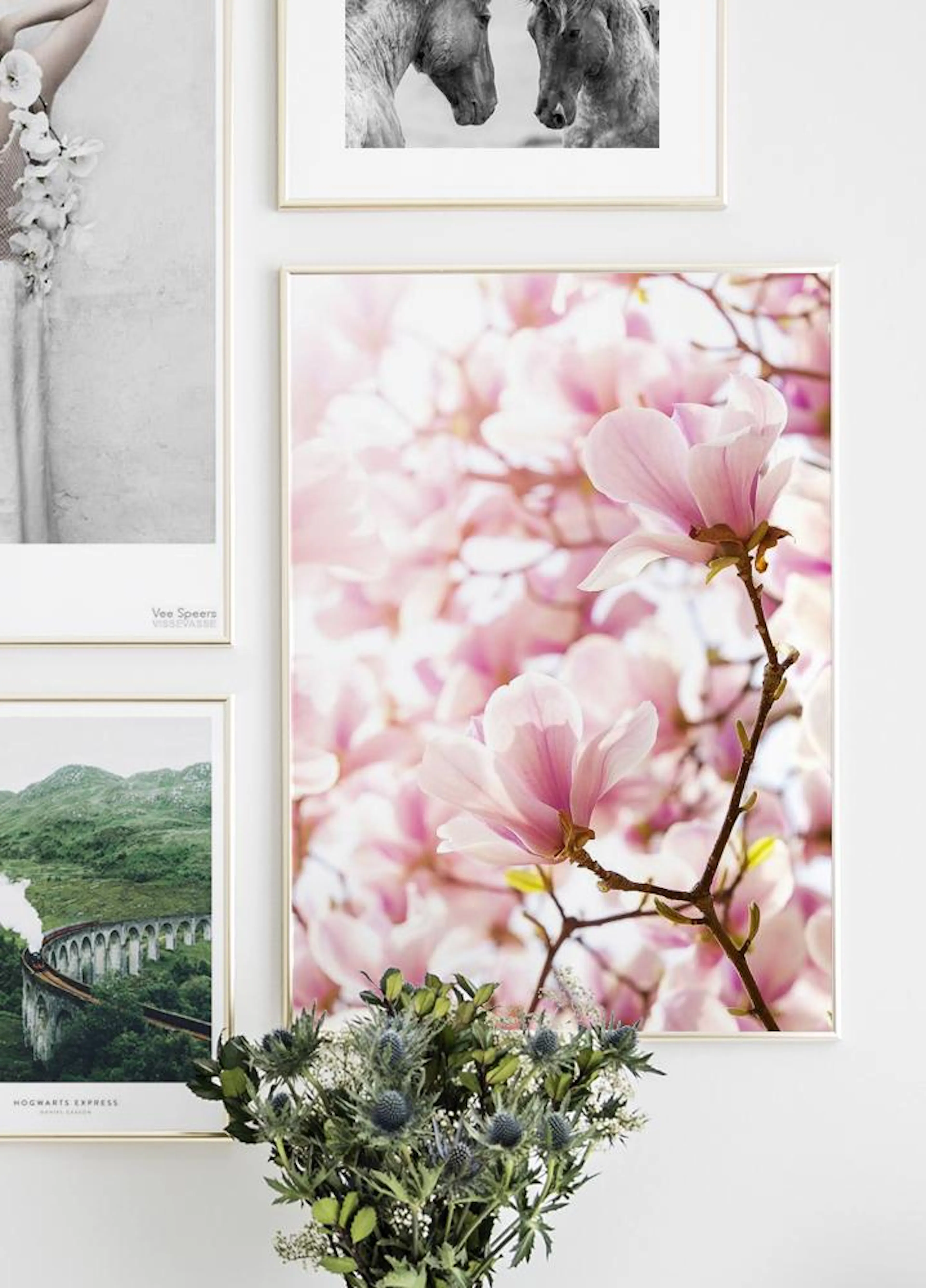 A stunning print showcasing two delicate pink magnolia blossoms on a branch, with a soft pink floral background, part of a galle