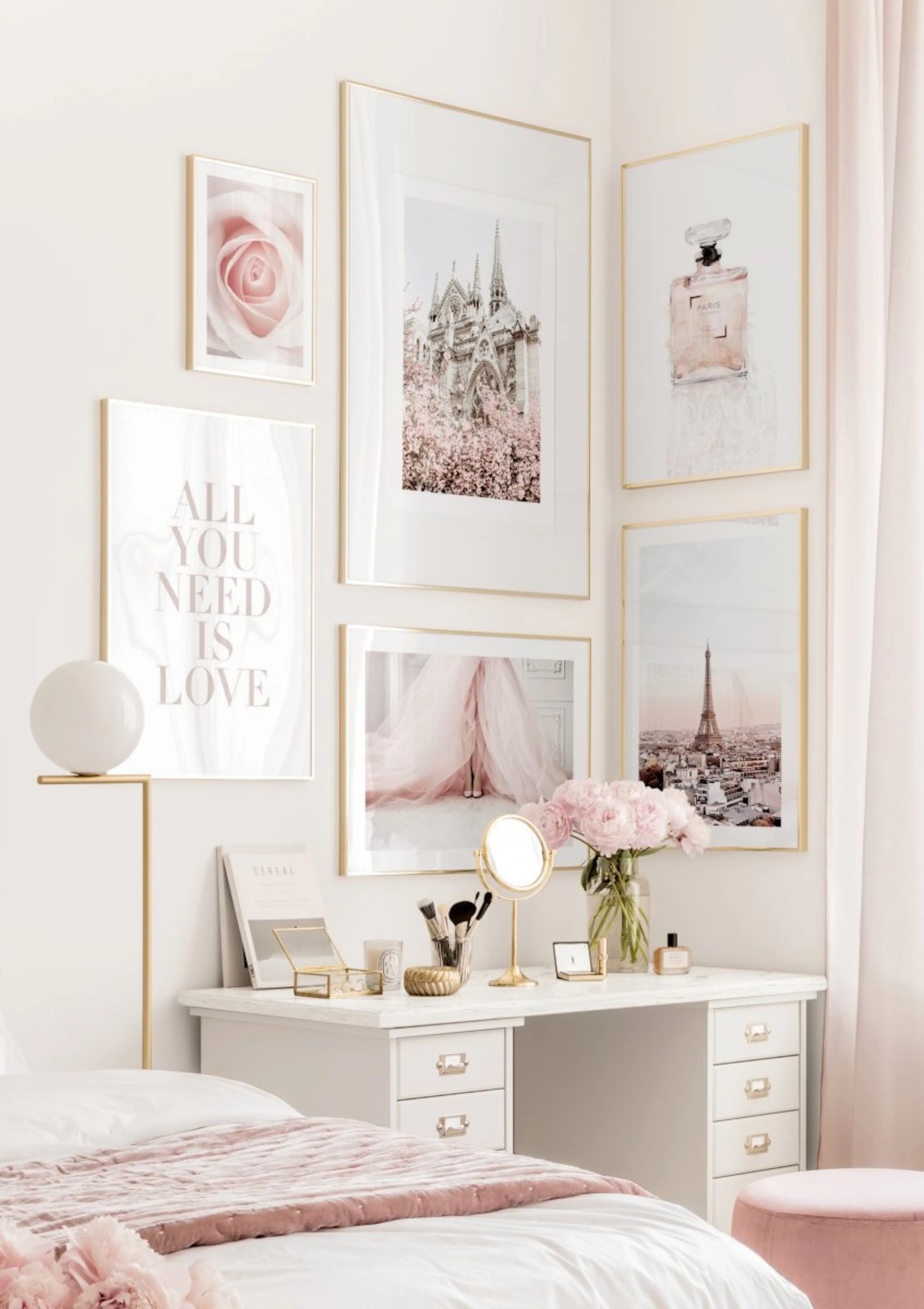 A gallery wall of Paris-themed posters with pink accents, including the Eiffel Tower, Notre Dame, and a rose, displayed above a 