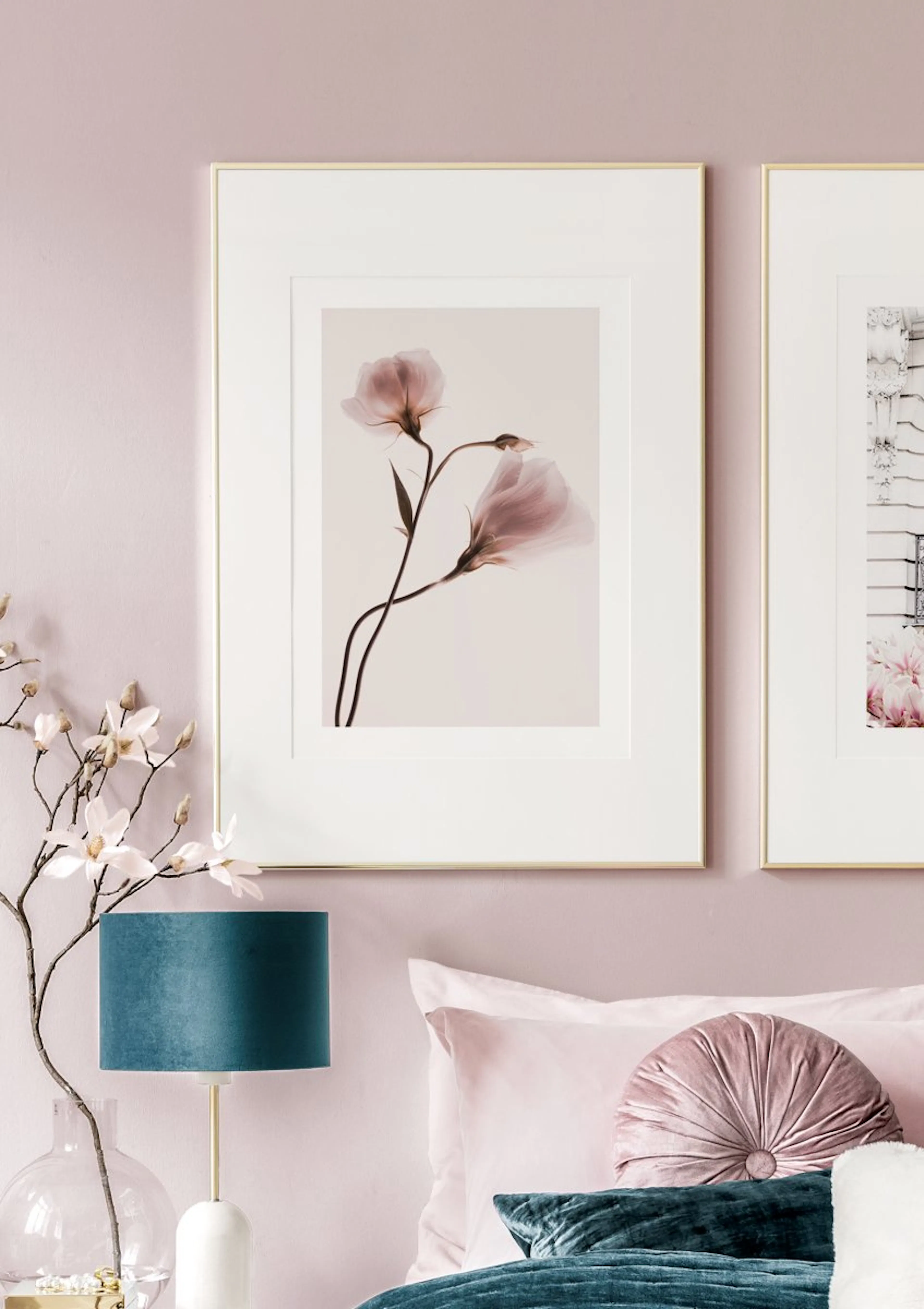 A poster featuring delicate pink translucent flowers on subtle stems, displayed in a bedroom with pink walls and bedding.