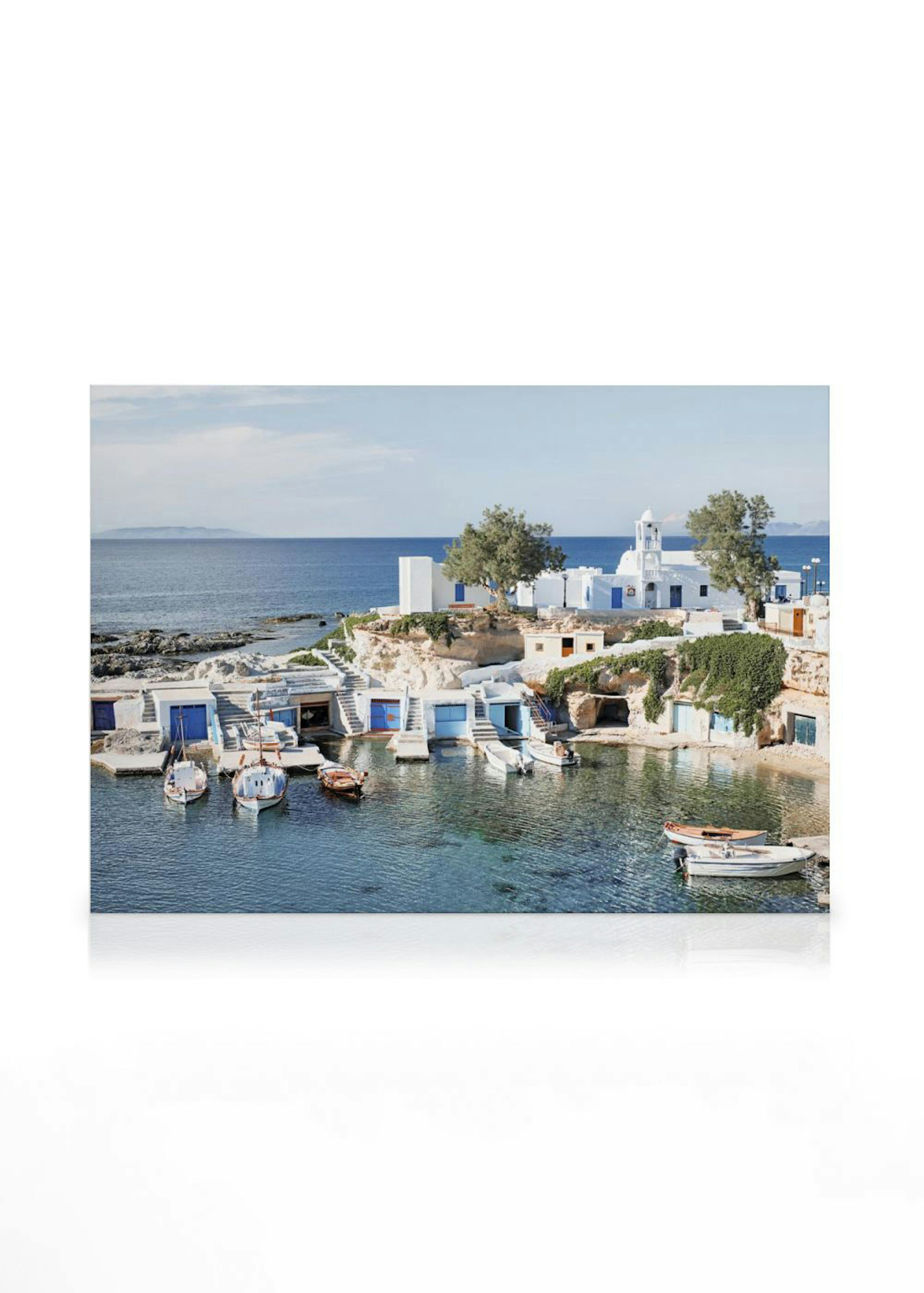 Obraz na plátně s pobřežní vesnicí s bílými domy, modrými dveřmi, čluny v průzračné zátoce a mořem.