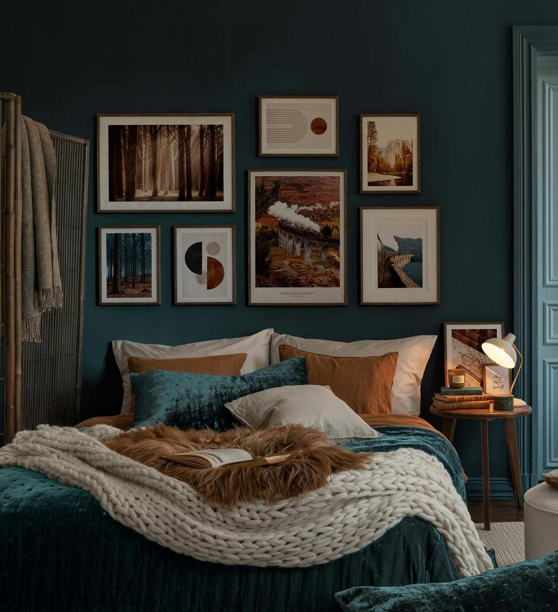 A gallery wall of posters above a bed, featuring a steam train, forest scenes, and abstract designs.
