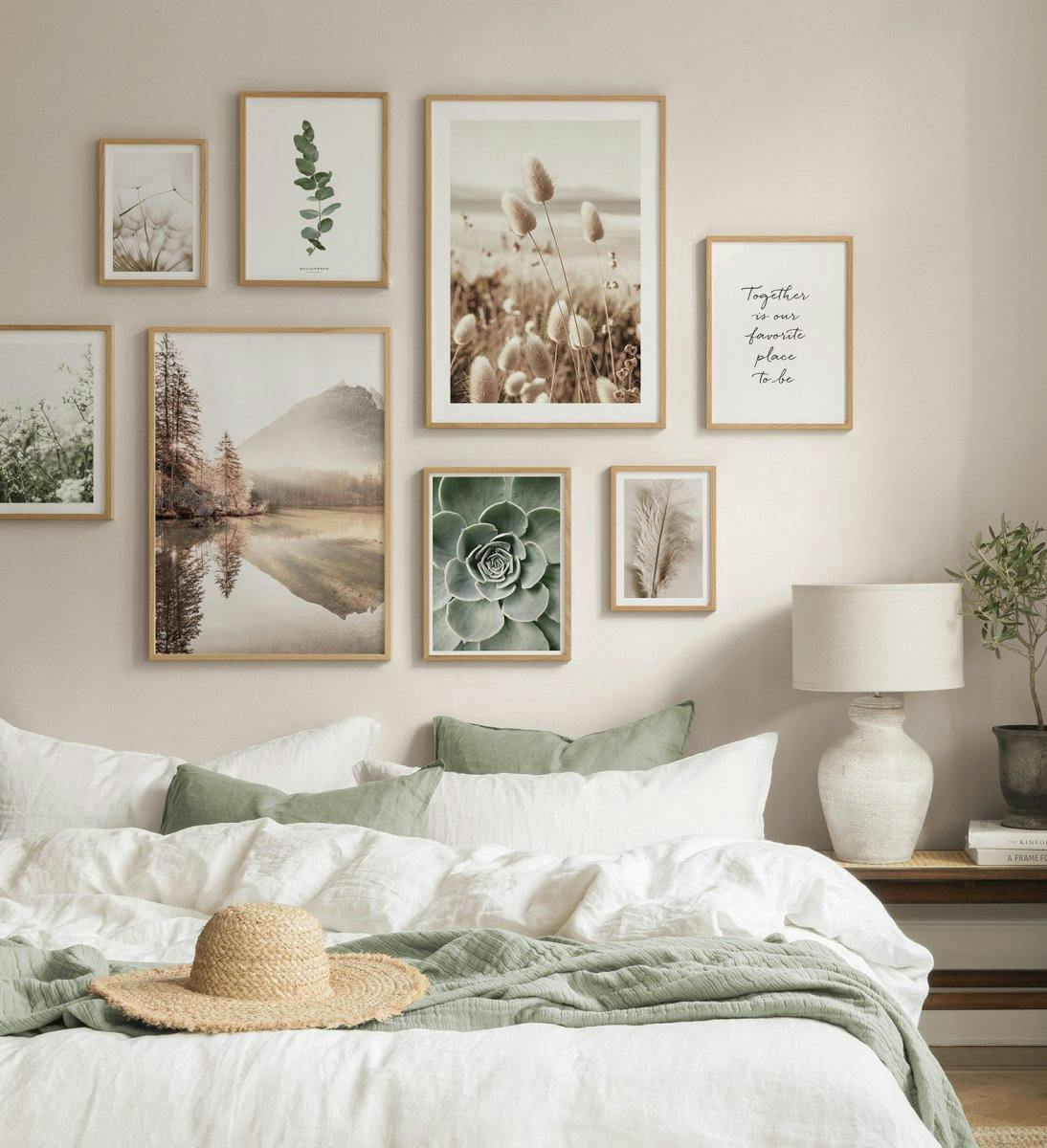 A collection of natural-themed posters on a bedroom wall, featuring landscapes, plants, and an inspirational quote.