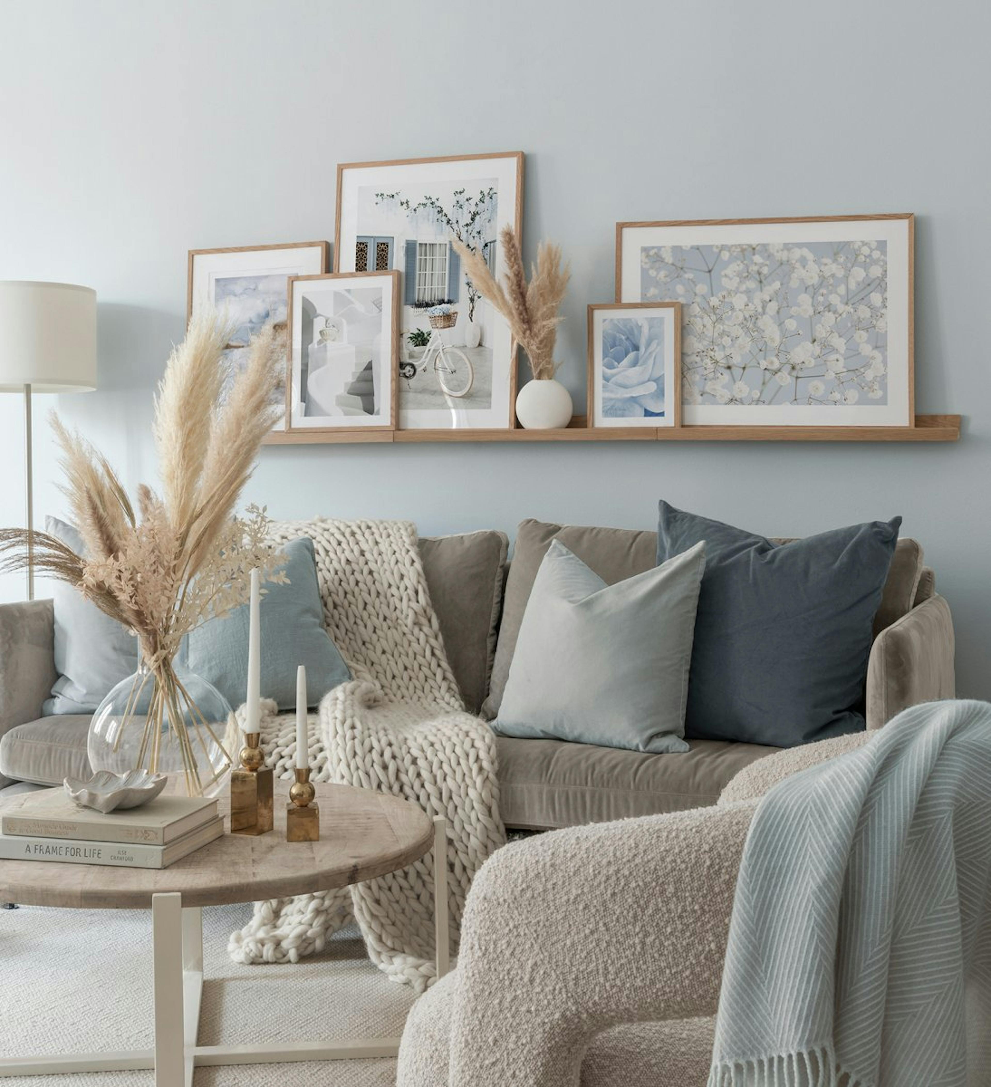 Blue and tropical gallery wall with nature prints with oak frames for living room