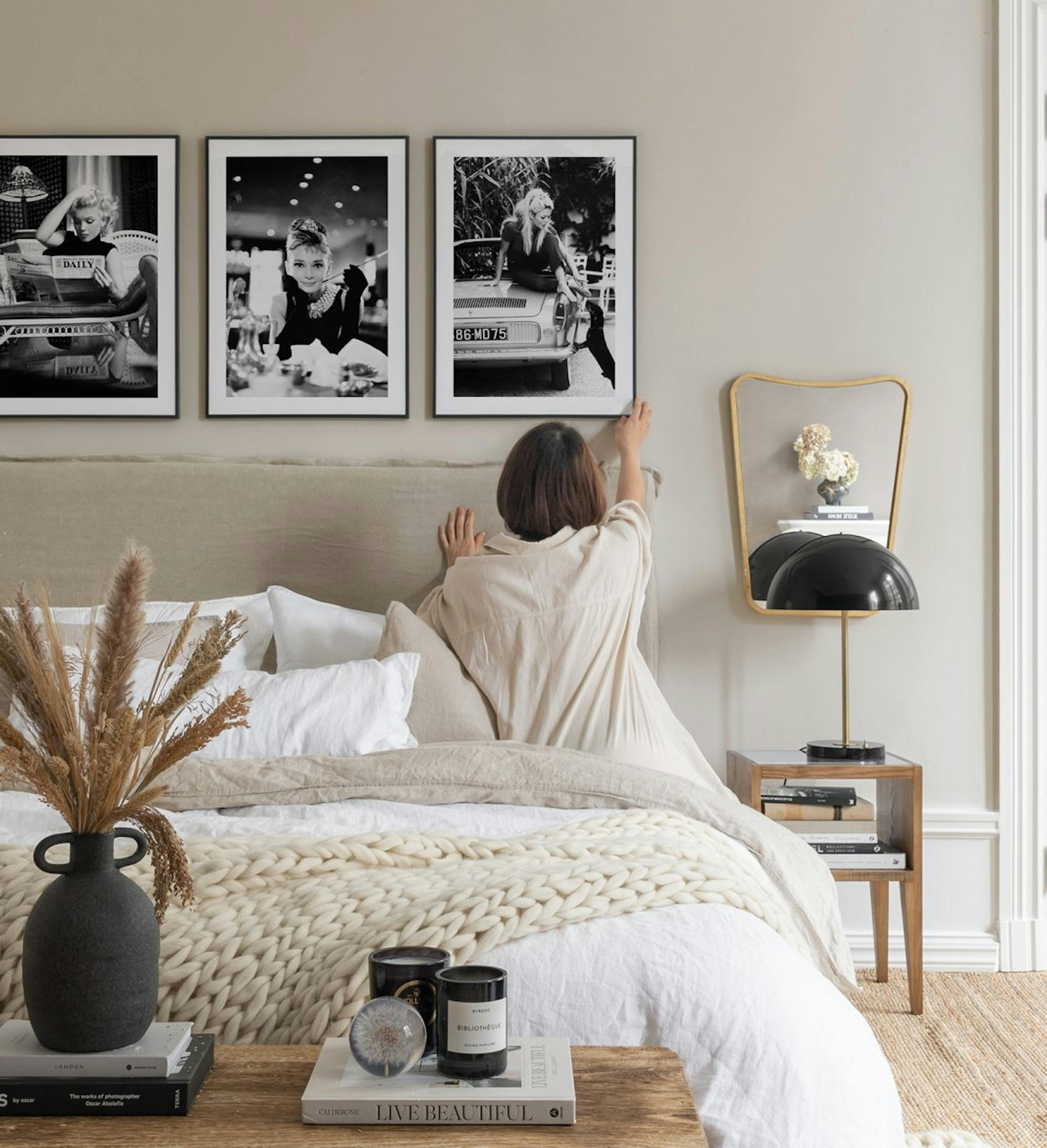 Modern and trendy gallery wall of famous celebrities in monochrome with black metal frames for bedroom