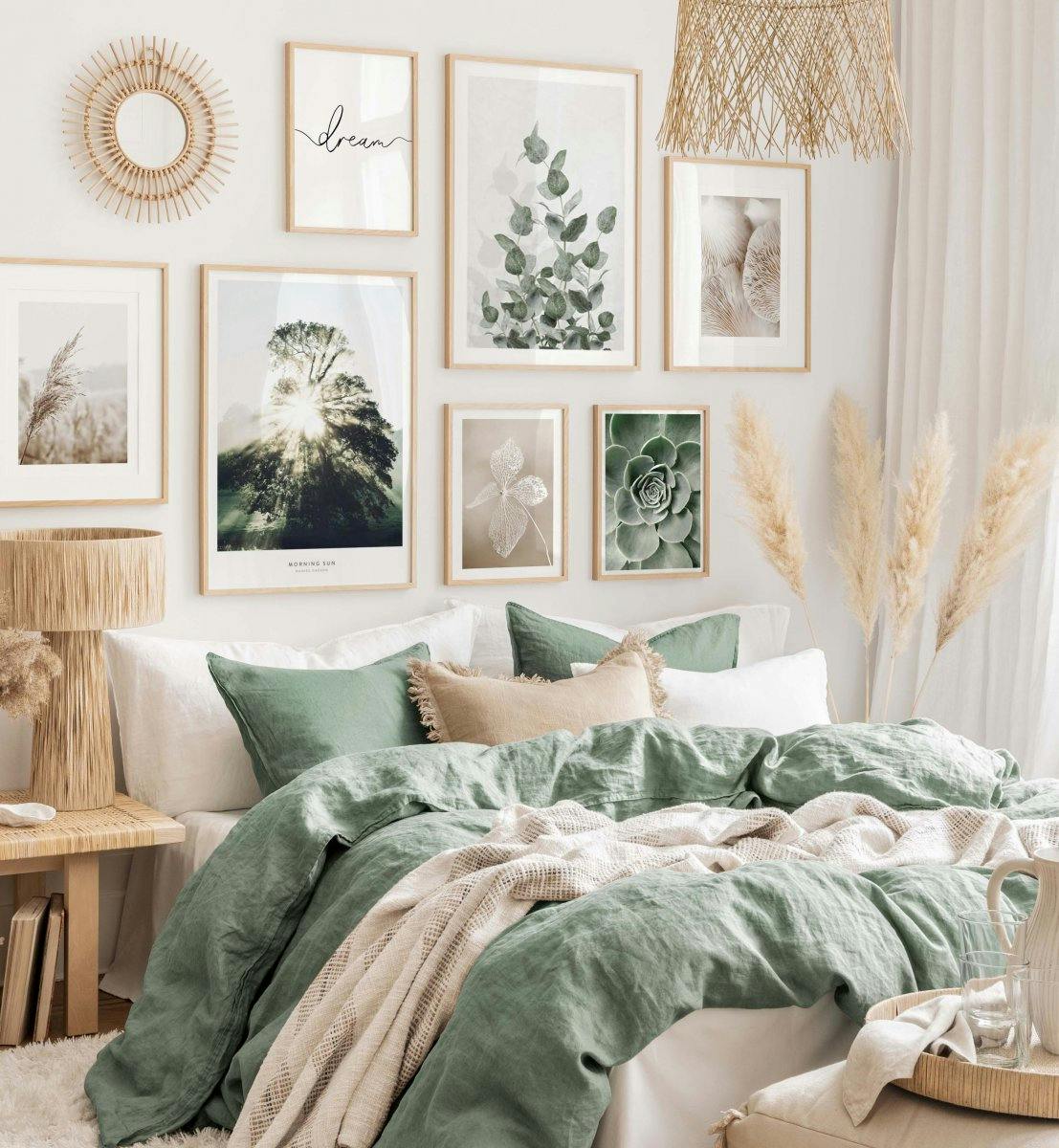 A poster gallery featuring nature and inspirational prints in a bedroom with green bedding.