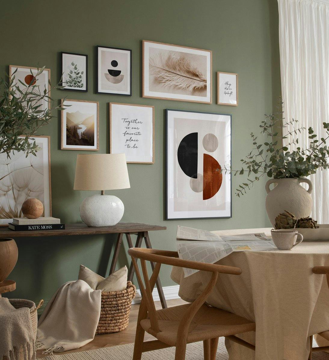A gallery wall featuring multiple posters in various sizes, including abstract shapes, a feather, and a landscape.