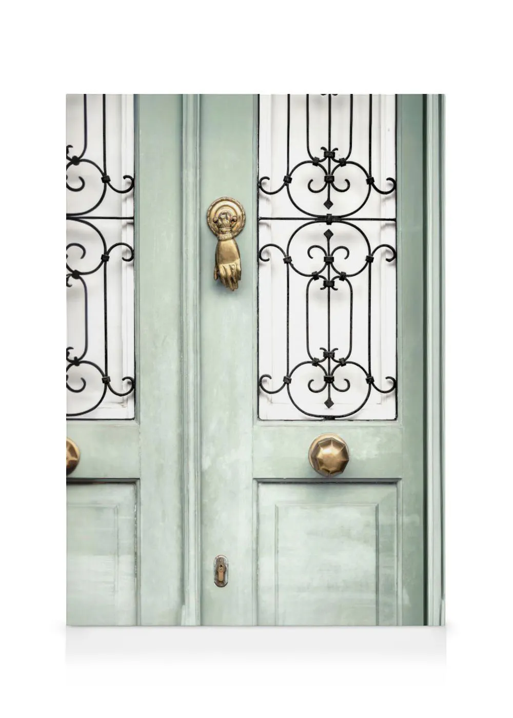 A canvas showing a mint green door with a golden hand-shaped knocker, brass doorknobs, and decorative black ironwork.