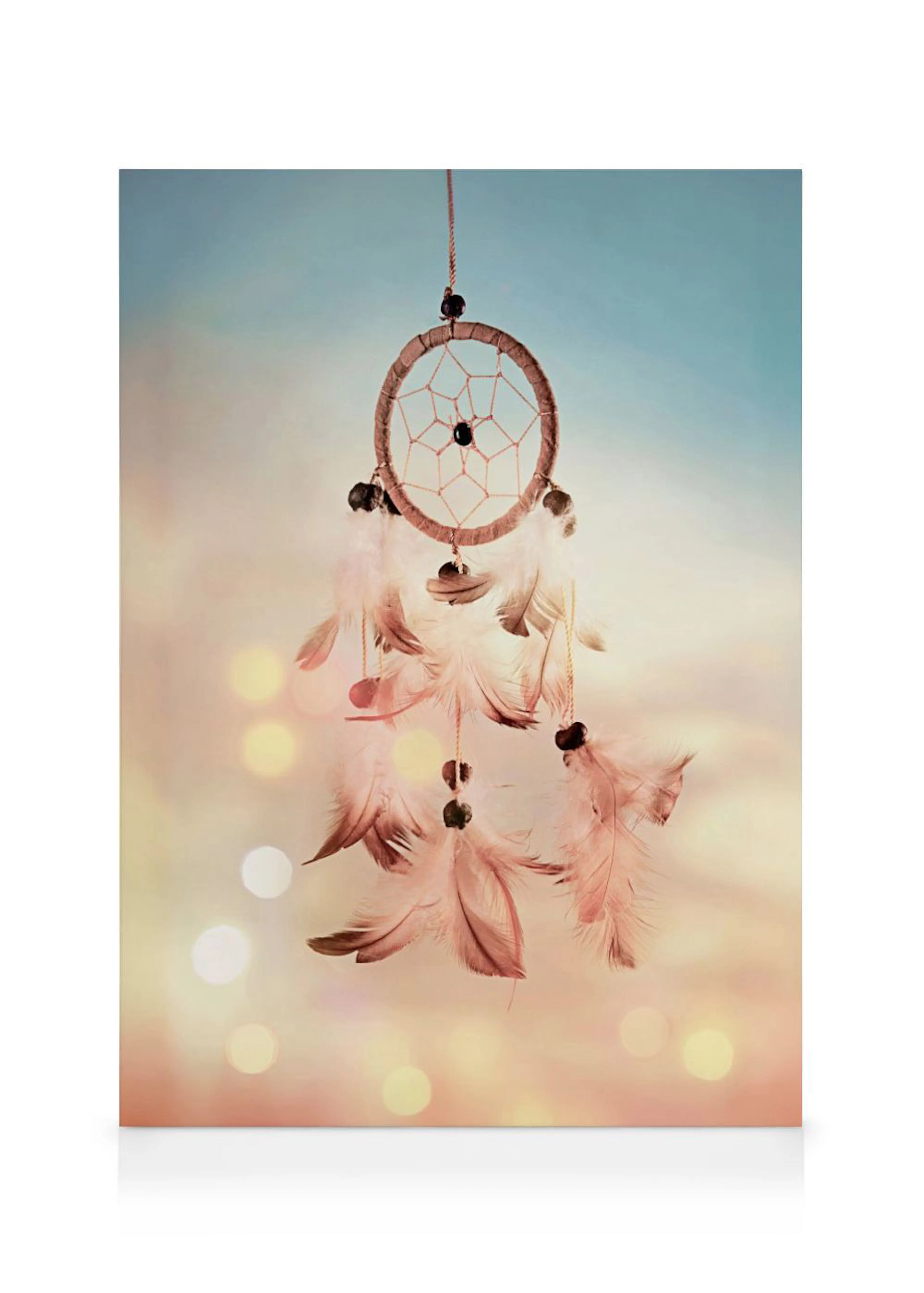 A dreamcatcher canvas featuring delicate feathers and beads, against a soft, bokeh-lit background.
