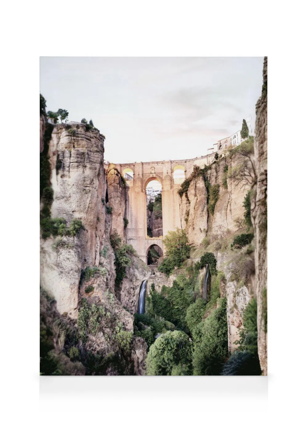 A canvas showing a tall Roman bridge with arches spanning a deep gorge in Ronda, Spain, with waterfalls and lush greenery.