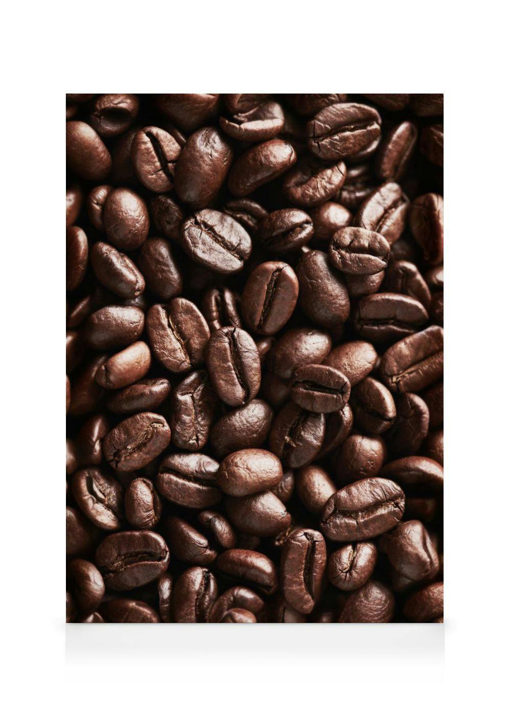 A canvas close-up of dark roasted coffee beans, showcasing their rich brown color and textured surfaces.