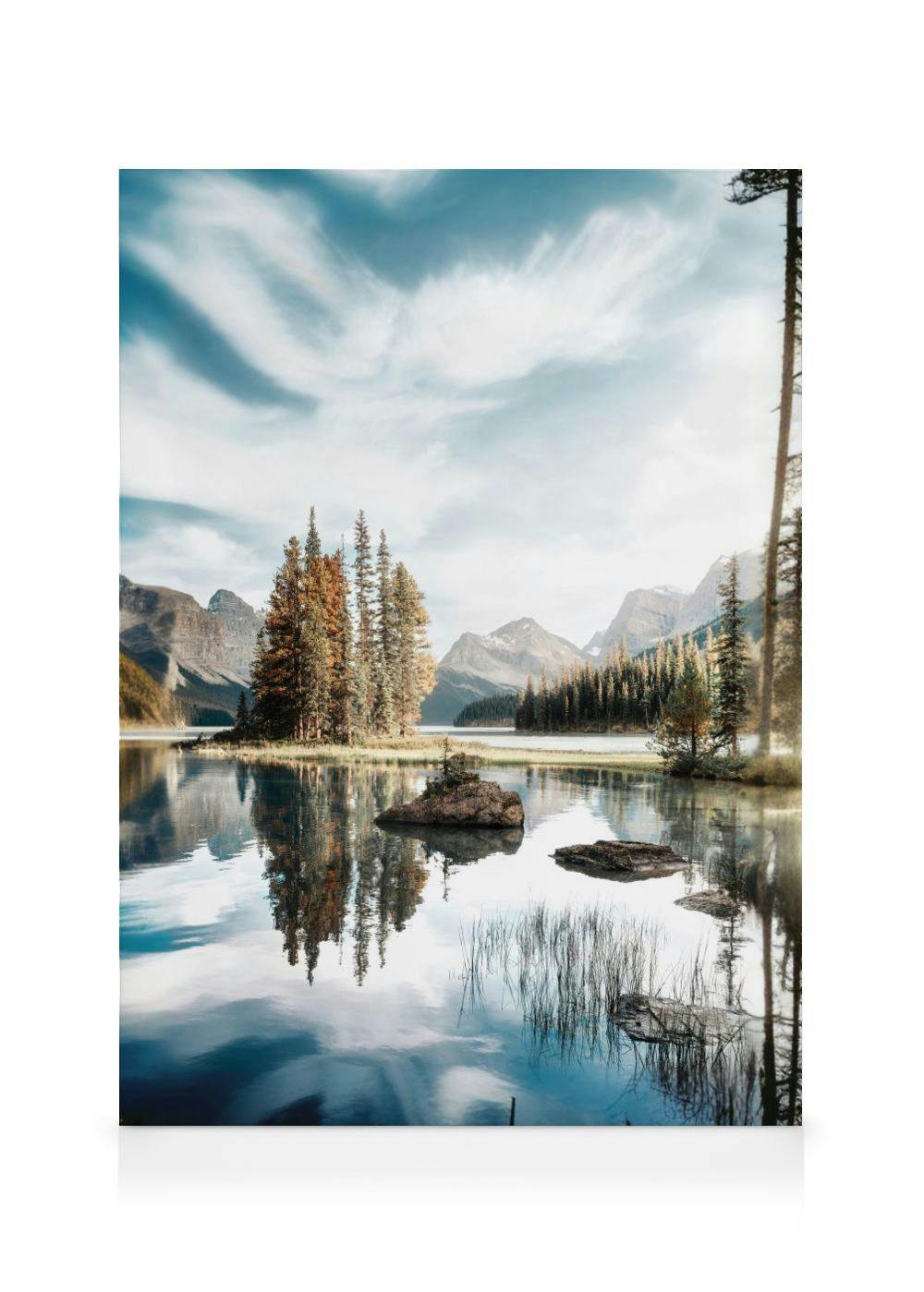 A canvas displaying a serene lake scene with a small island of trees and mountains under a cloudy sky.
