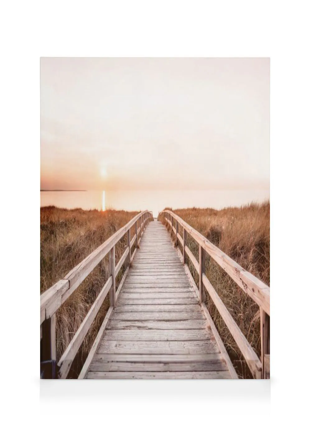 A canvas showing a wooden boardwalk leading through tall grass towards a sunset over a calm body of water.