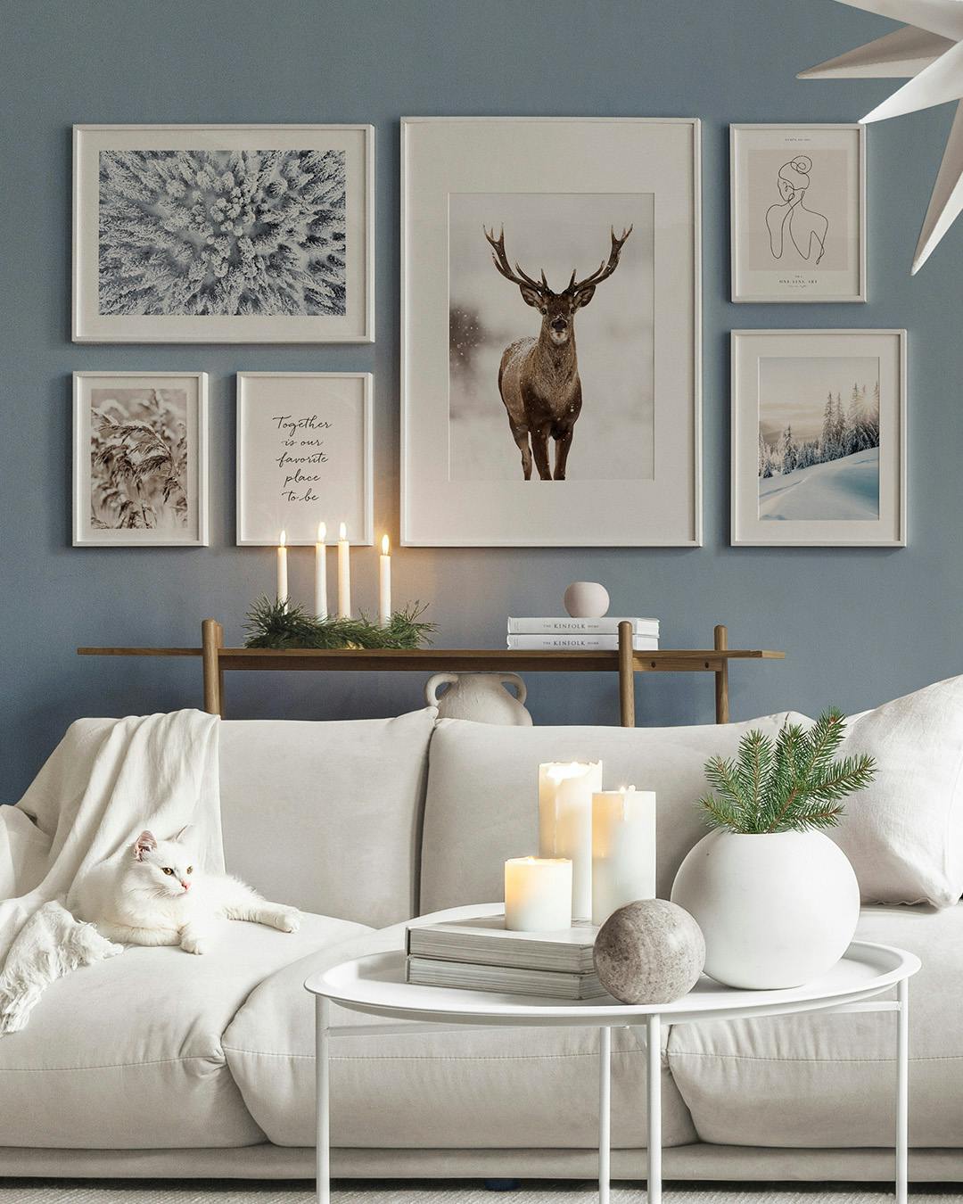 Une décoration murale avec un cerf enneigé, une forêt dhiver, un dessin de femme et une citation inspirante.
