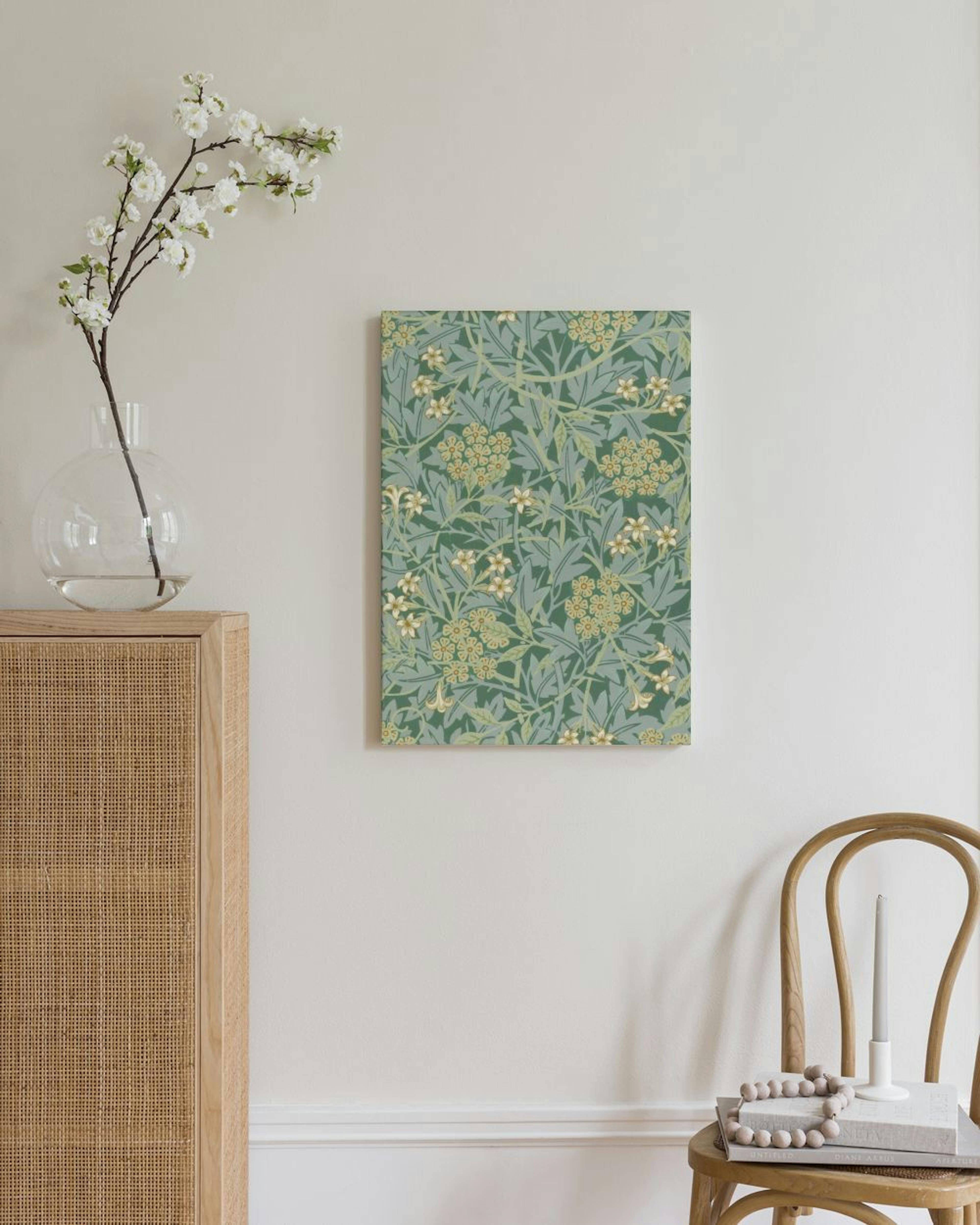 A canvas with a green floral pattern featuring light green leaves and yellow flowers, hanging in a minimalist living room.