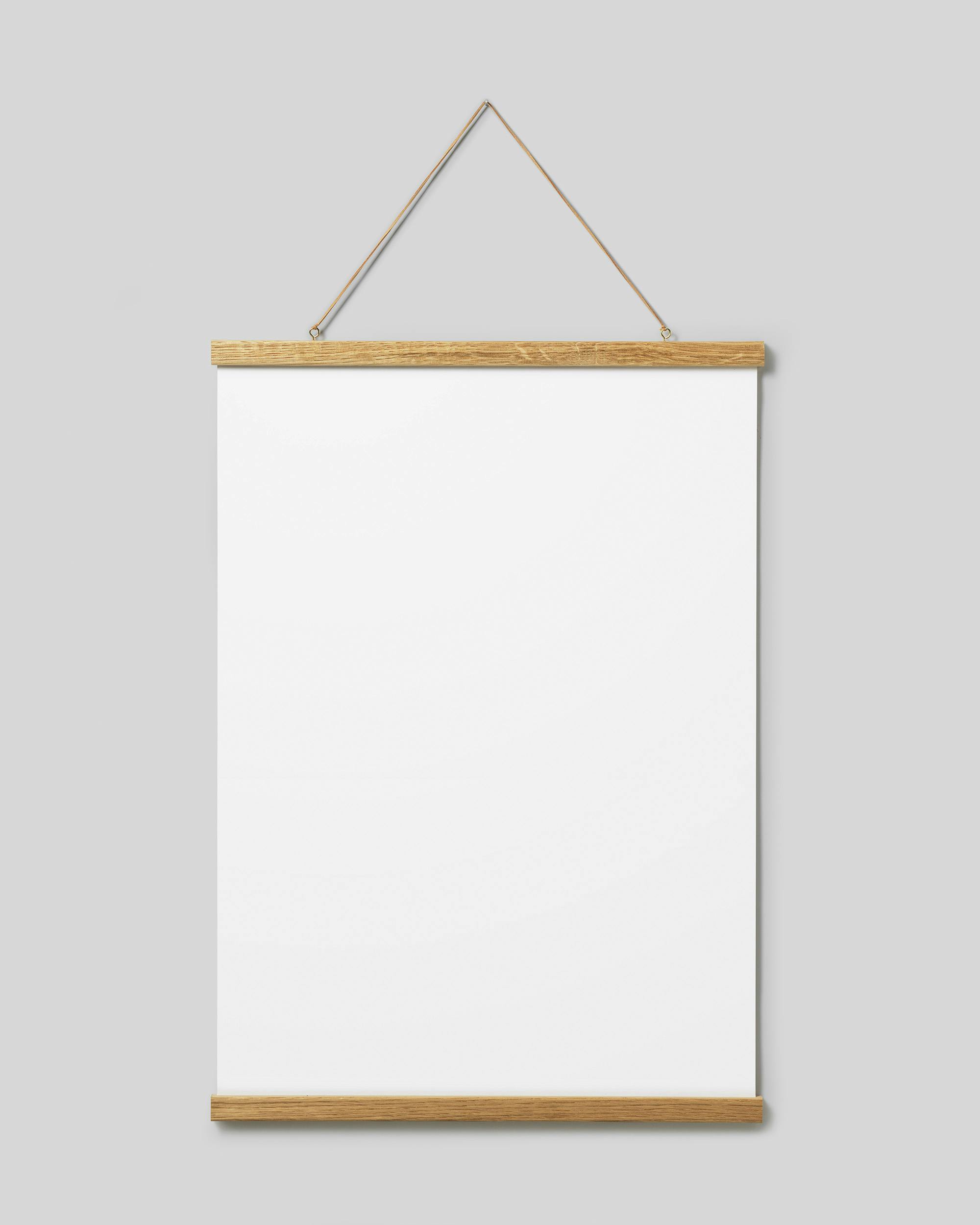 A blank white poster hanging from a light wooden hanger with a string on a light grey wall.