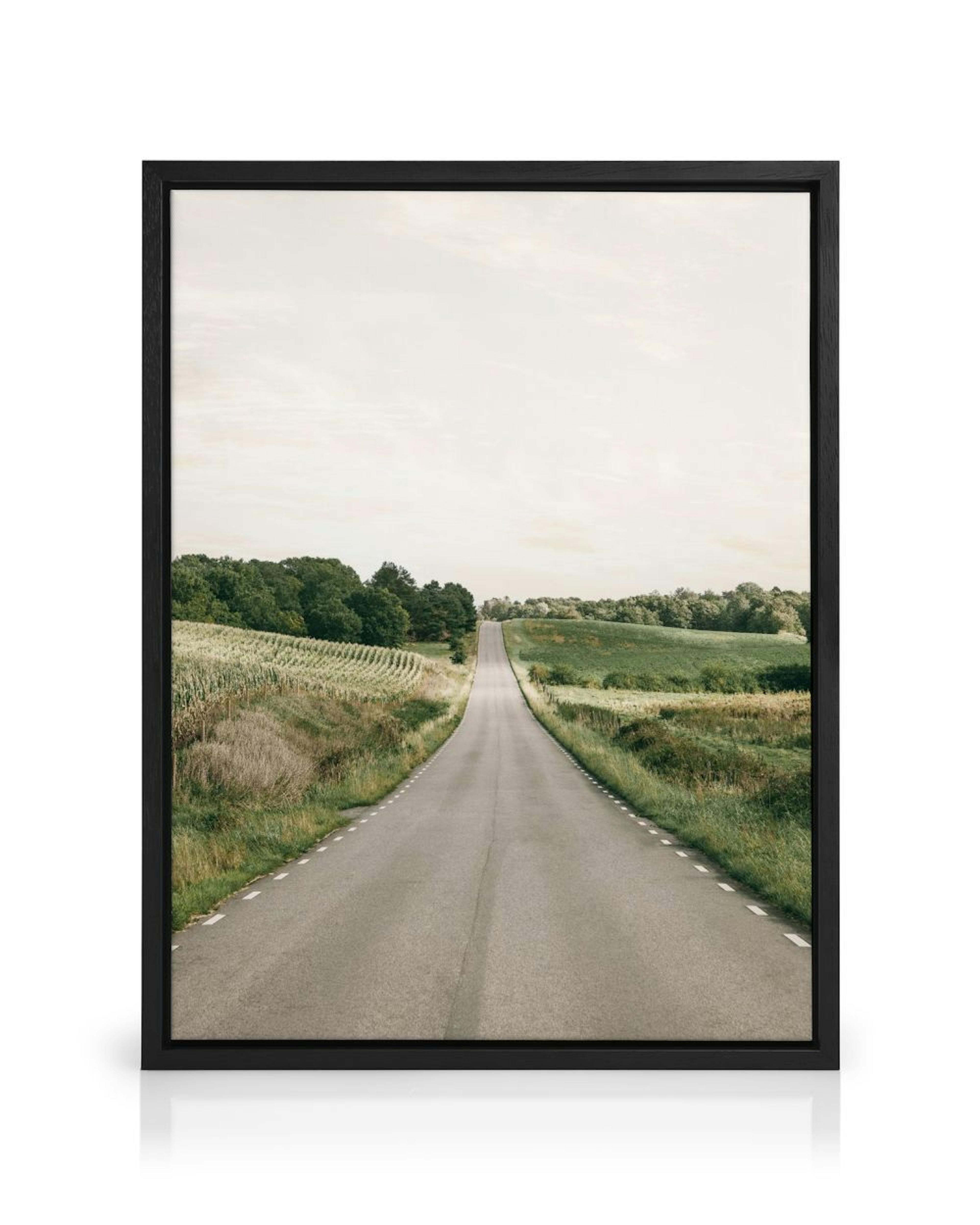 A canvas showing a long, grey road stretching into the distance, flanked by green fields and trees under a light sky.
