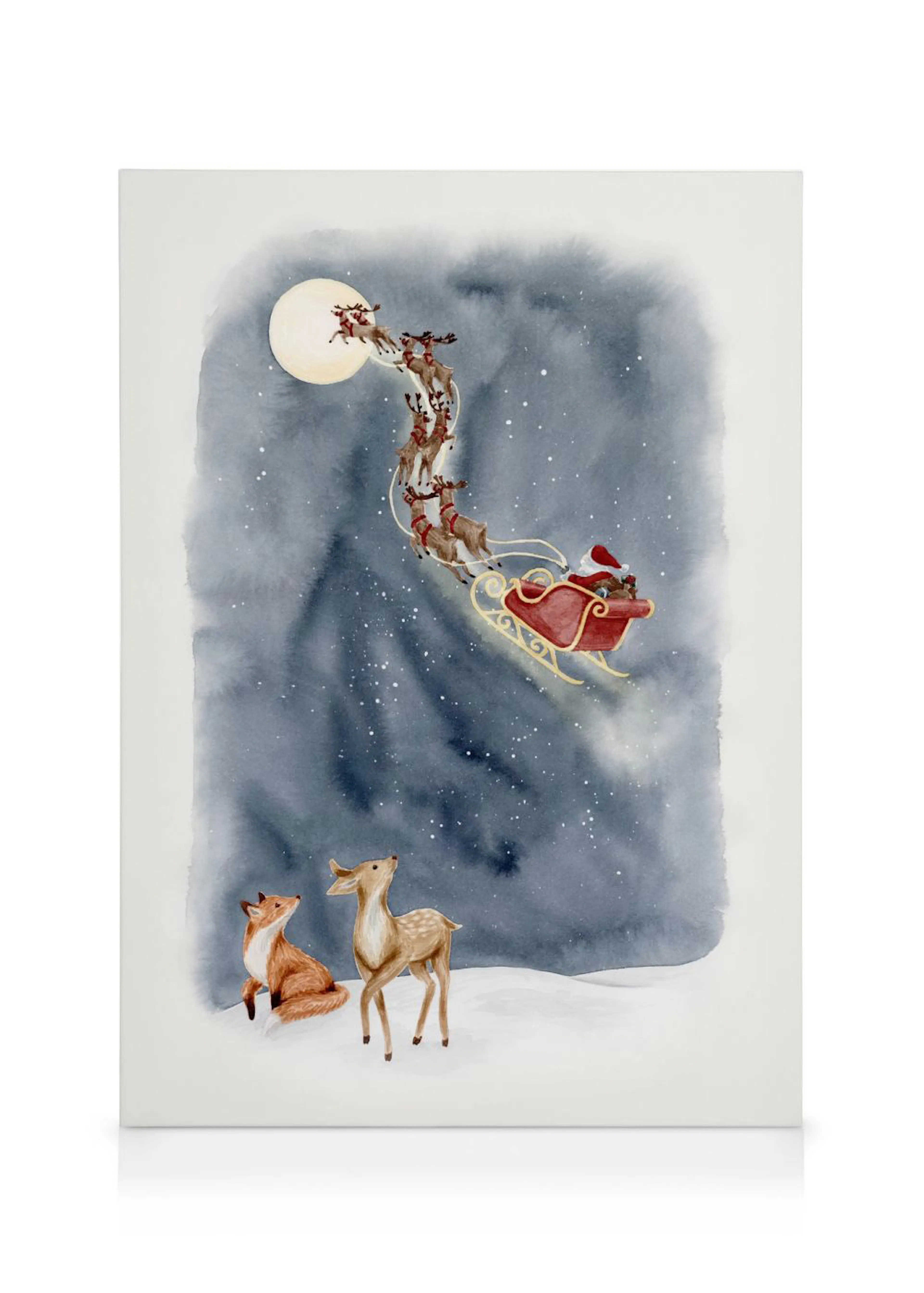 Toile de Noël représentant le Père Noël dans son traîneau avec des rennes, survolant un renard et un chevreuil sous la lune.