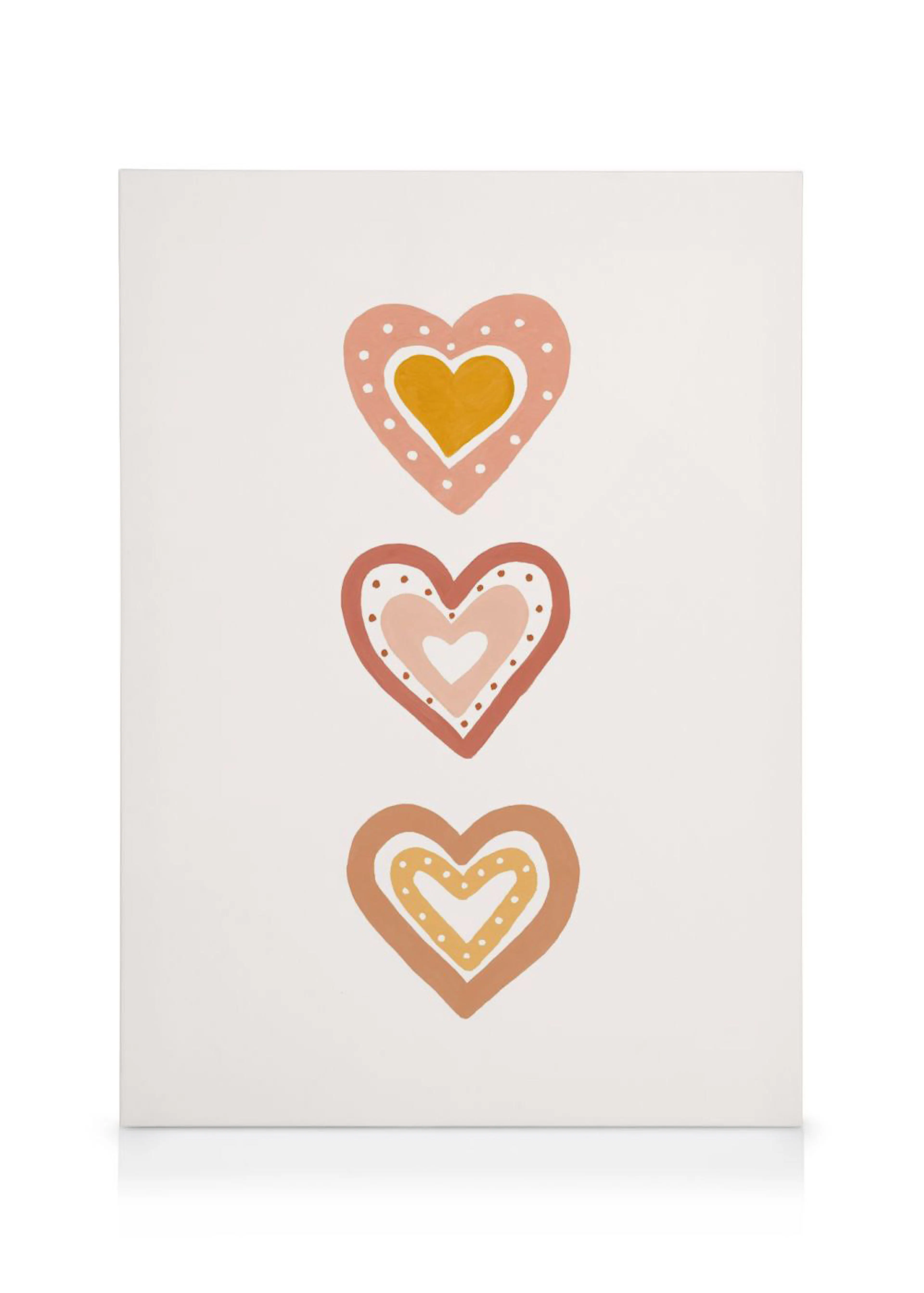 A canvas featuring three stacked hearts in warm tones of pink, orange, and brown with white dotted details.