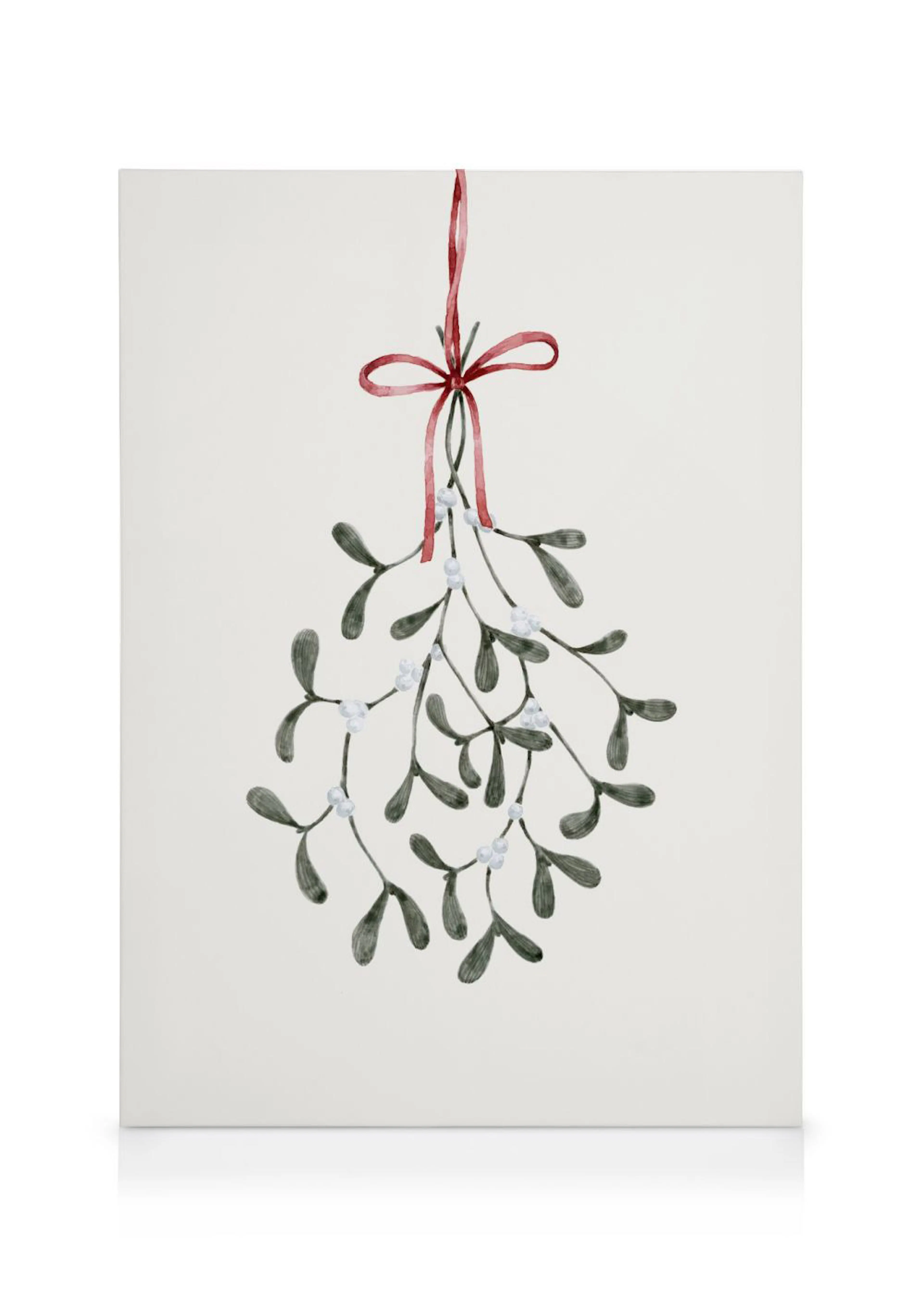 Een canvas met een aquarel van een maretak met donkere bladeren en witte bessen, hangend aan een rood lint.