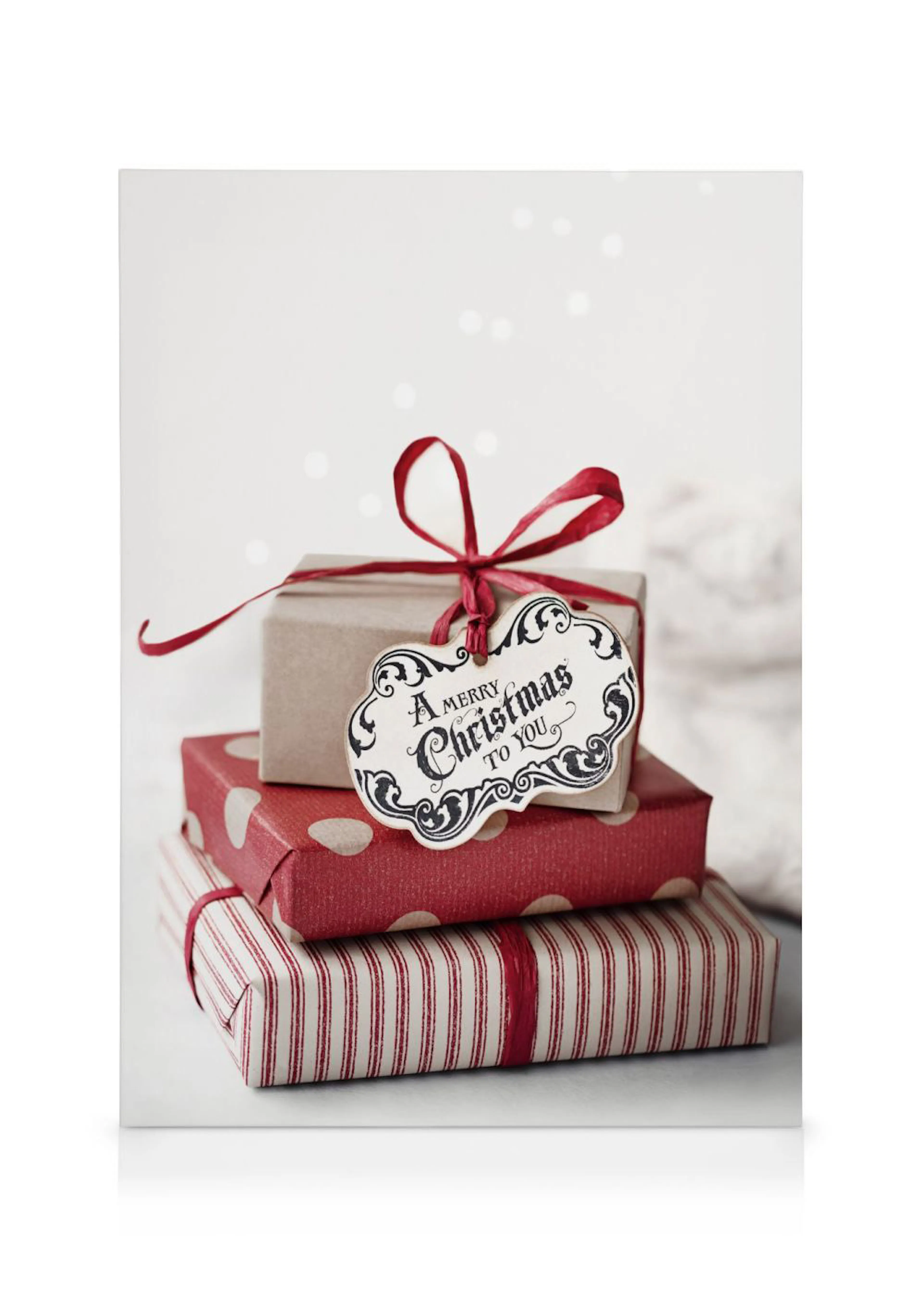 Obraz na plátně se třemi vánočními dárky svázanými červenou stuhou s visačkou A Merry Christmas to You.