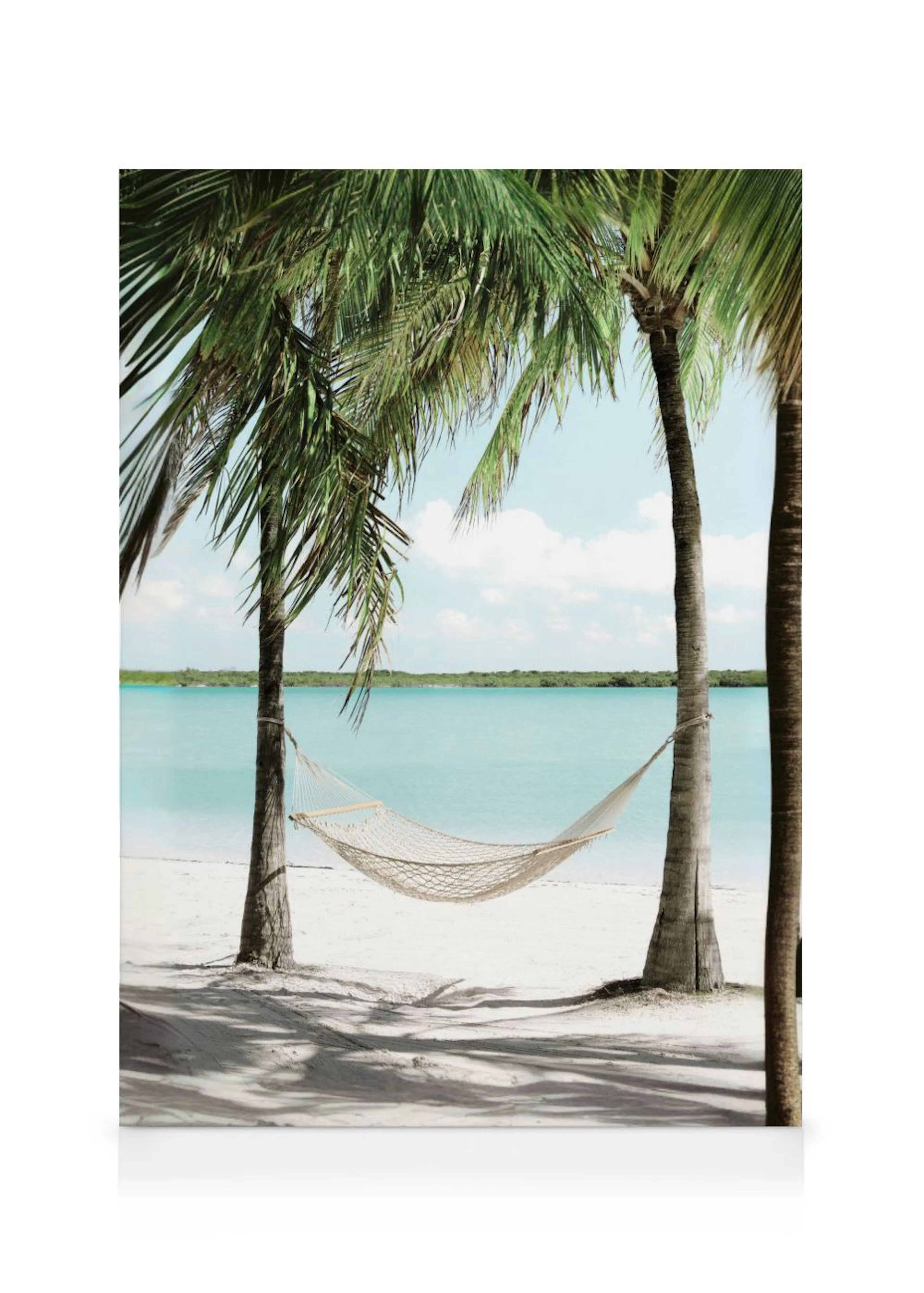 A canvas of a white hammock strung between two palm trees on a white sand beach with turquoise water and a distant green landmas
