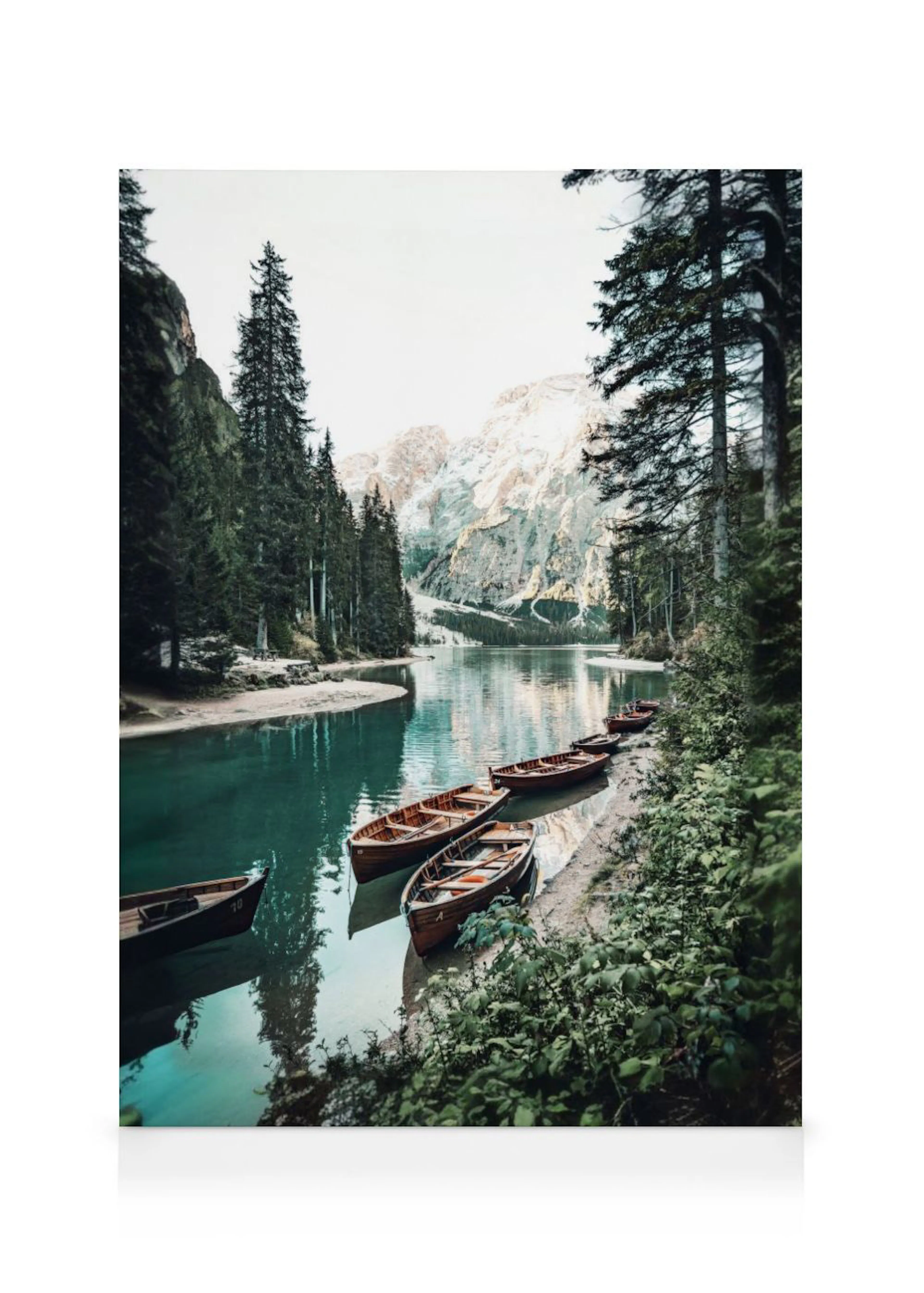 A stunning canvas of a serene mountain lake with wooden boats docked along the shore, surrounded by lush evergreen trees and sno