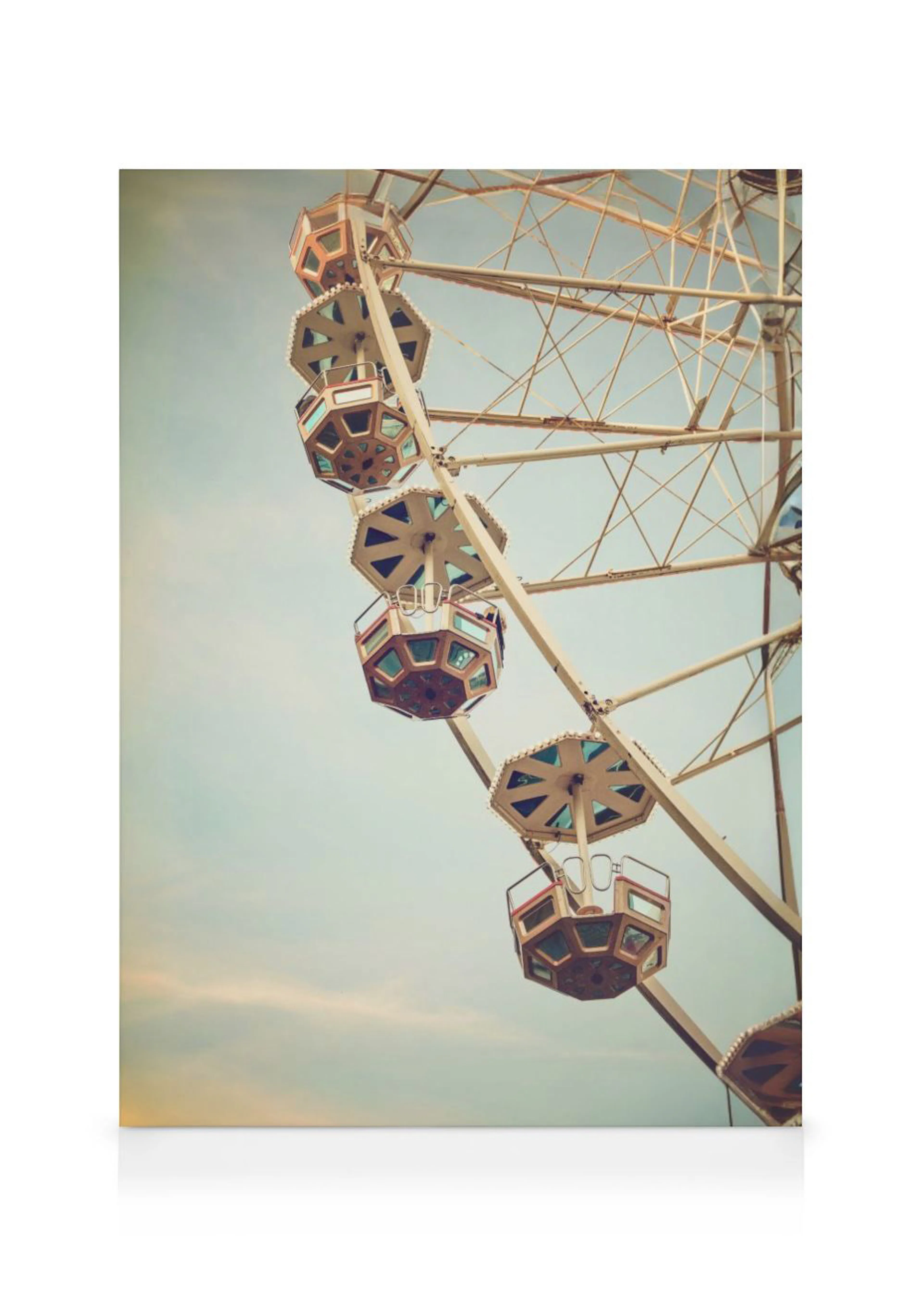 A canvas displaying a vintage-style photograph of a Ferris wheel against a clear sky, with several empty passenger gondolas visi