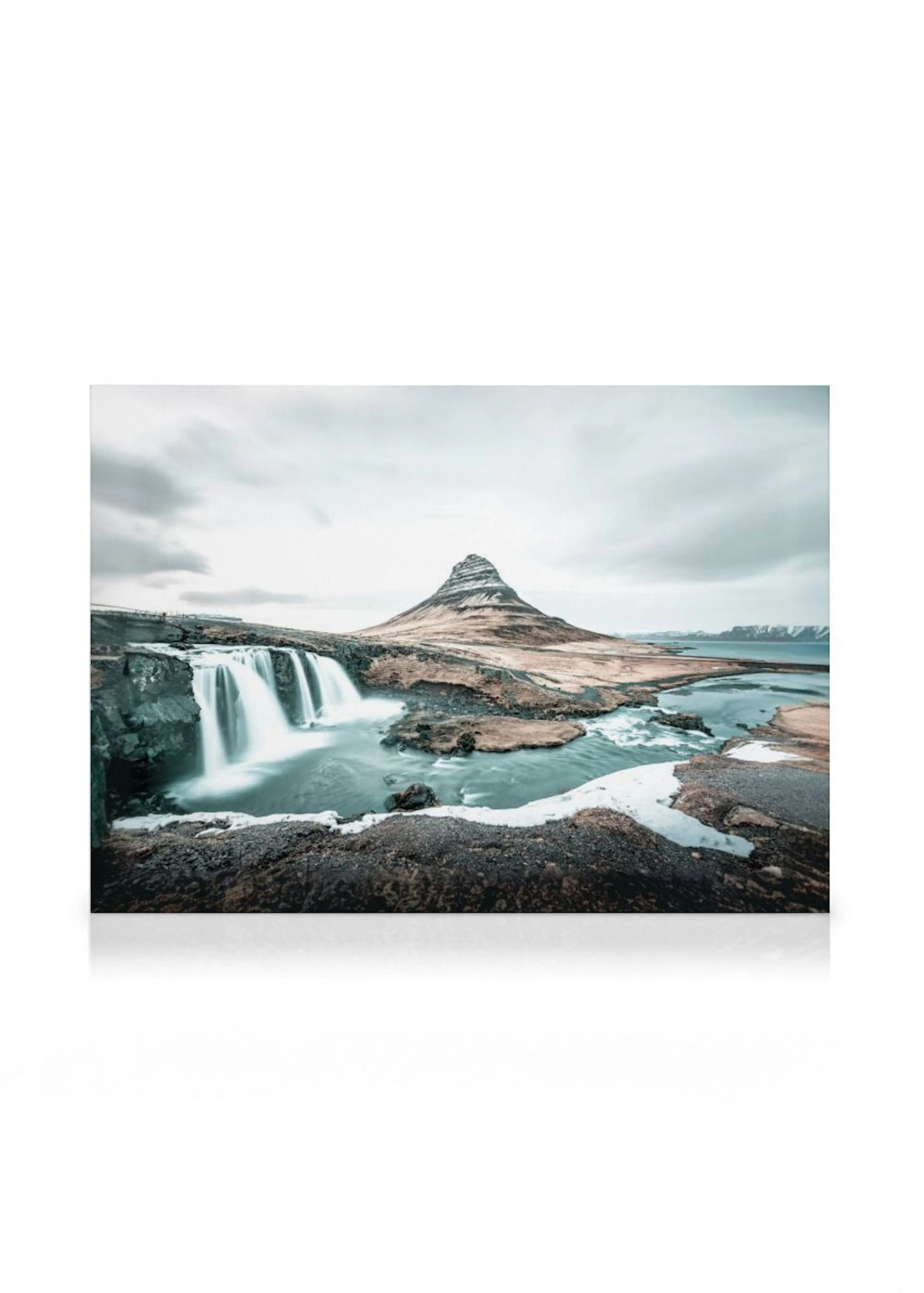A canvas showing a misty waterfall flowing under a cloudy sky with a mountain in the background.
