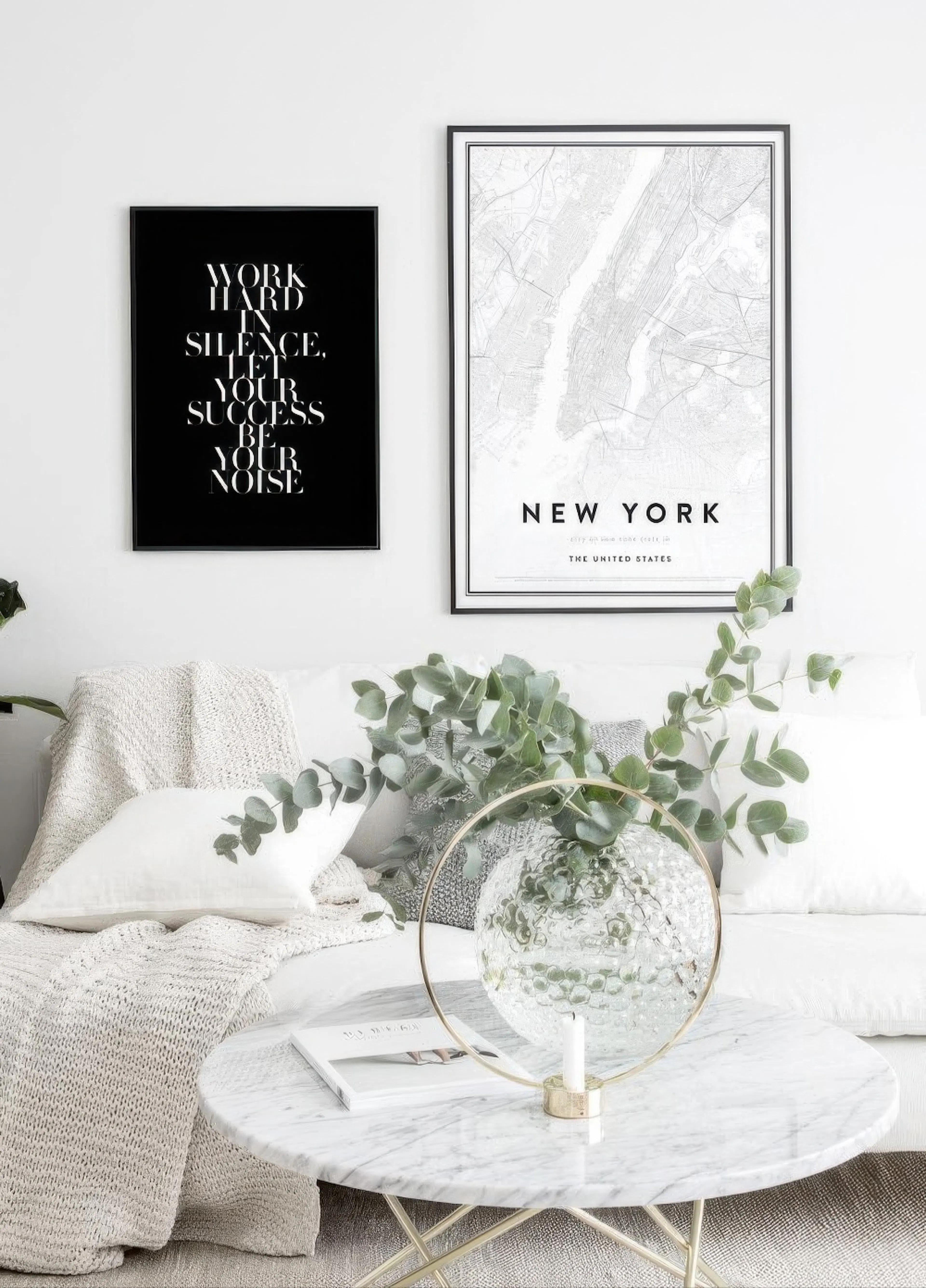 A poster with the quote Work hard in silence. Let your success be your noise and a New York map poster, displayed above a white 