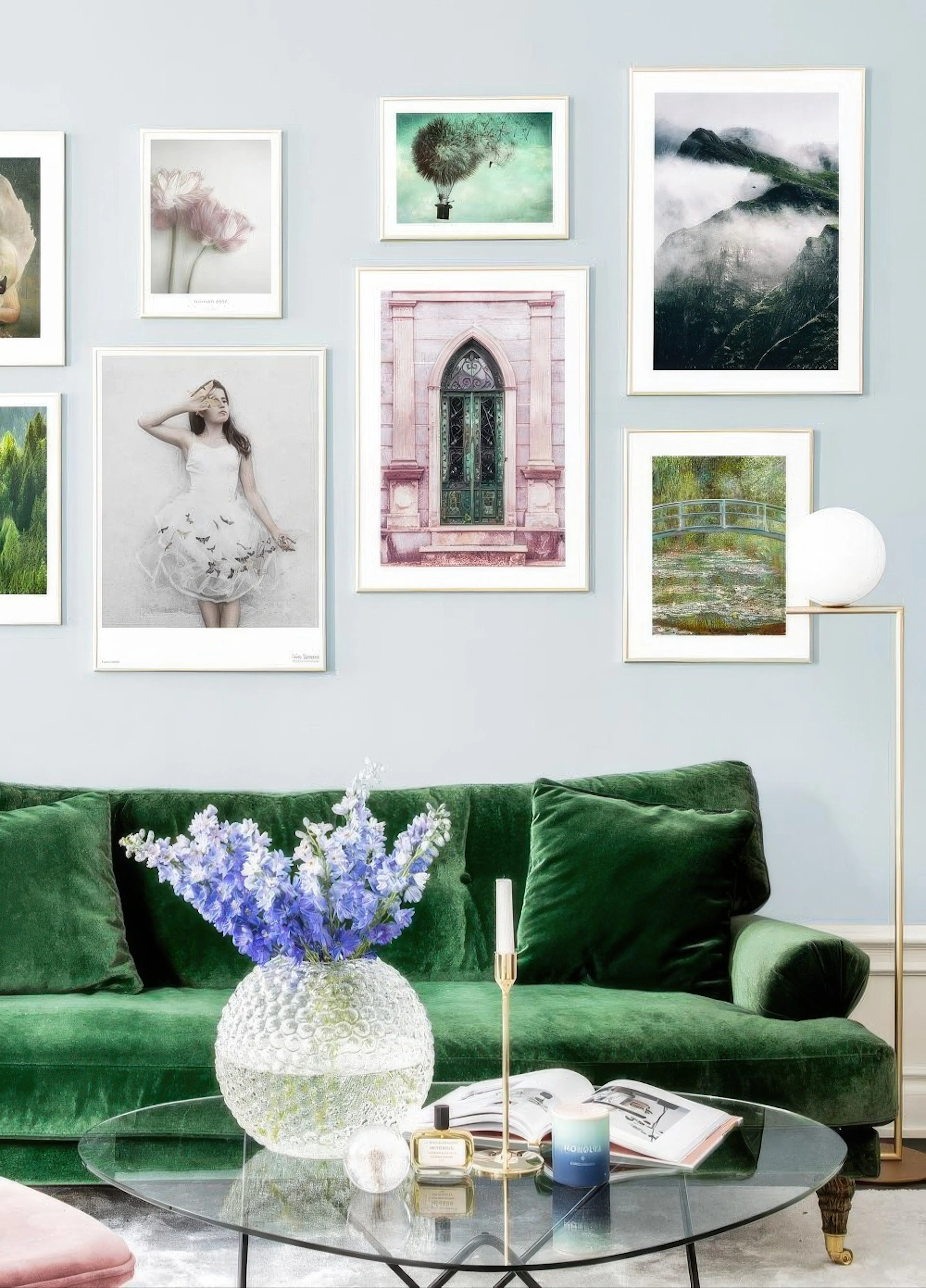 A gallery wall of diverse posters including a swan, florals, hot air balloon, mountains, a gothic door, a woman in white, and Mo
