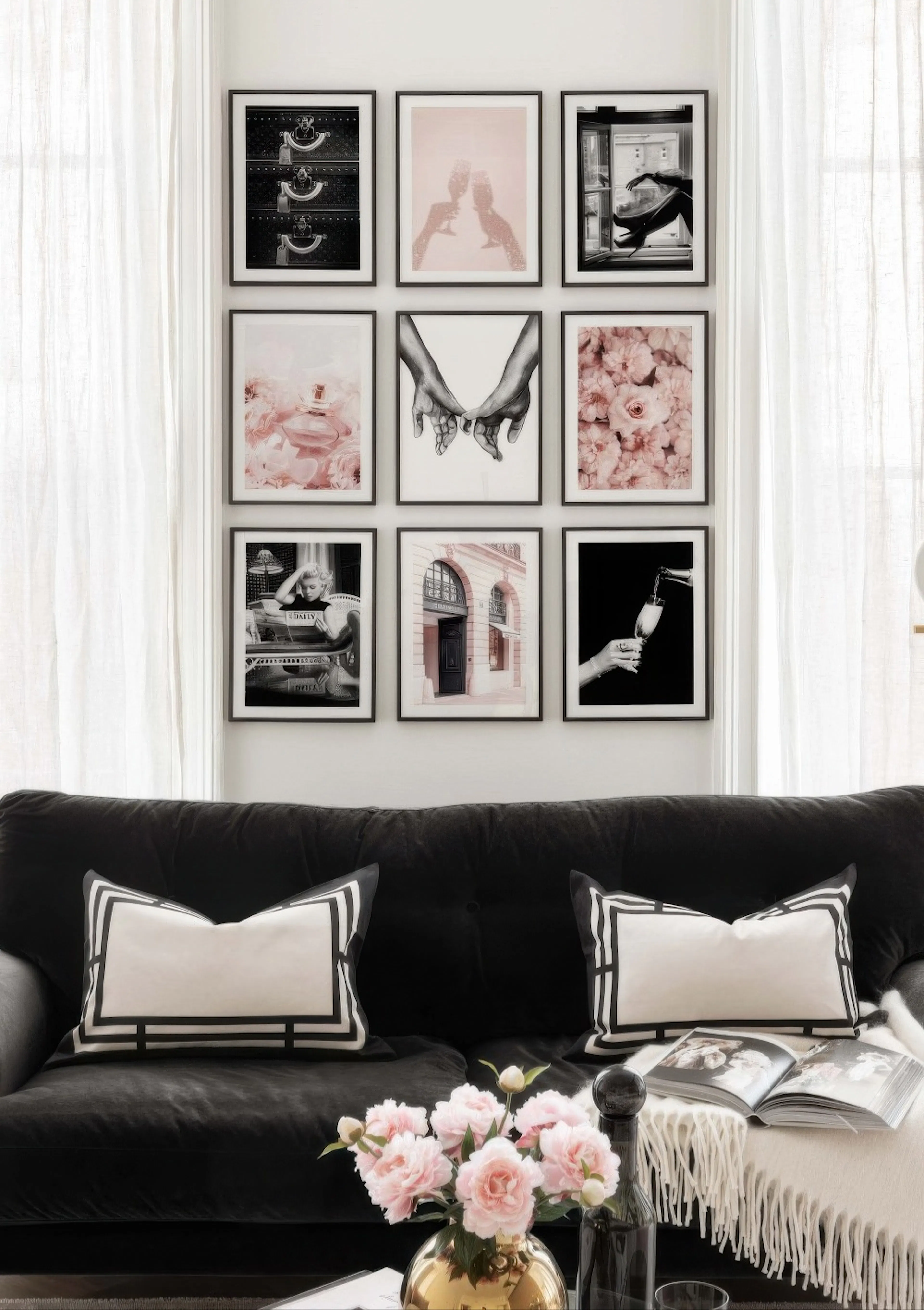 A gallery wall of black and white and pink prints, including champagne flutes, hands, and flowers, displayed above a black sofa.