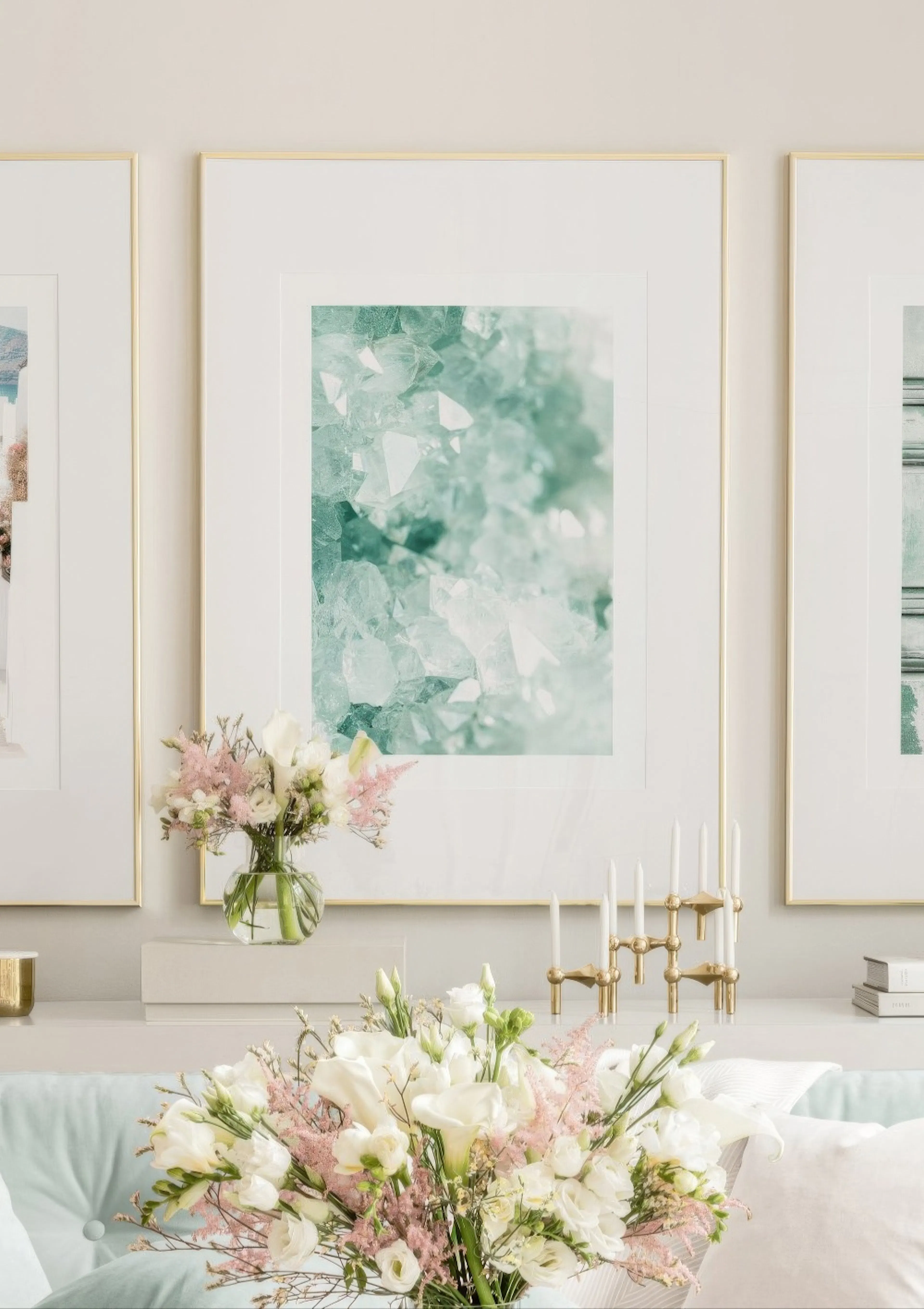 A poster featuring a close-up of teal and white crystal formations, displayed above a console table with flowers in a modern liv