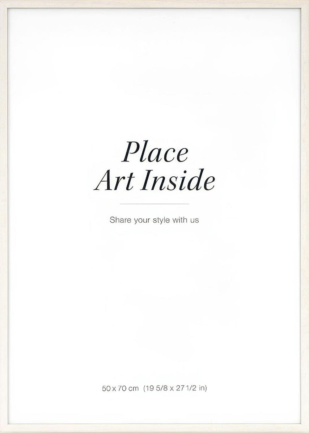 A poster with a light wood frame and white interior, featuring Place Art Inside and Share your style with us text.