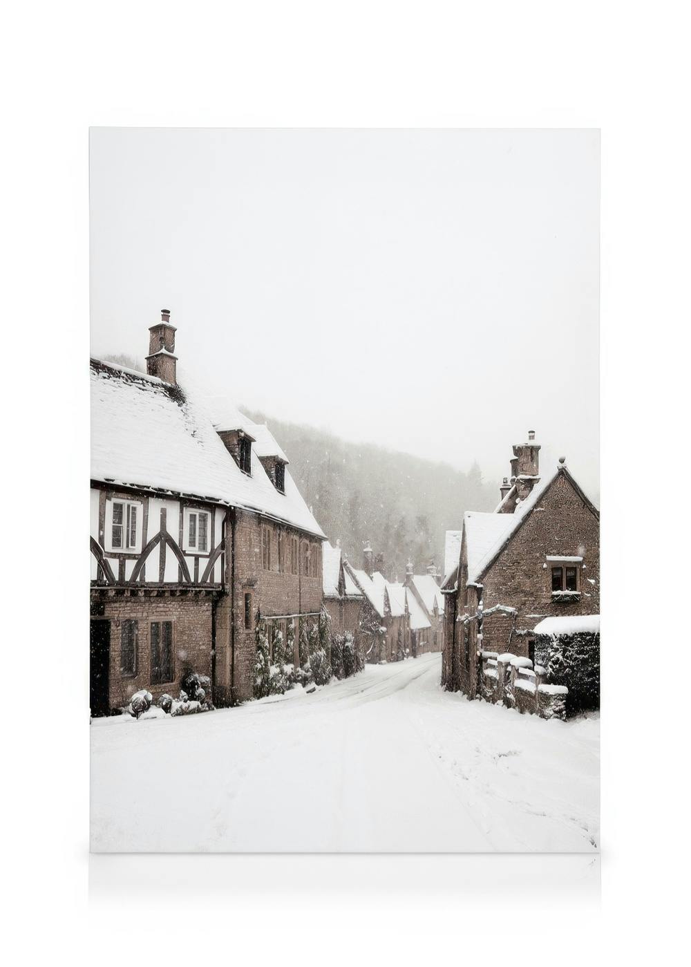 A canvas showing a snowy village street lined with traditional stone houses and timber-framed buildings.