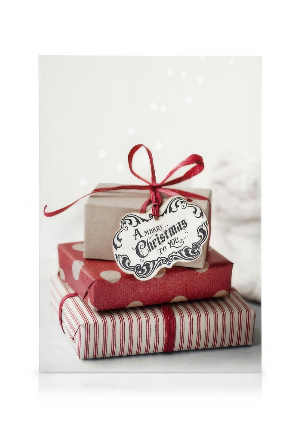 Weihnachtliches Leinwandbild mit einem Stapel festlich verpackter Geschenke und einem Etikett: A Merry Christmas to You.