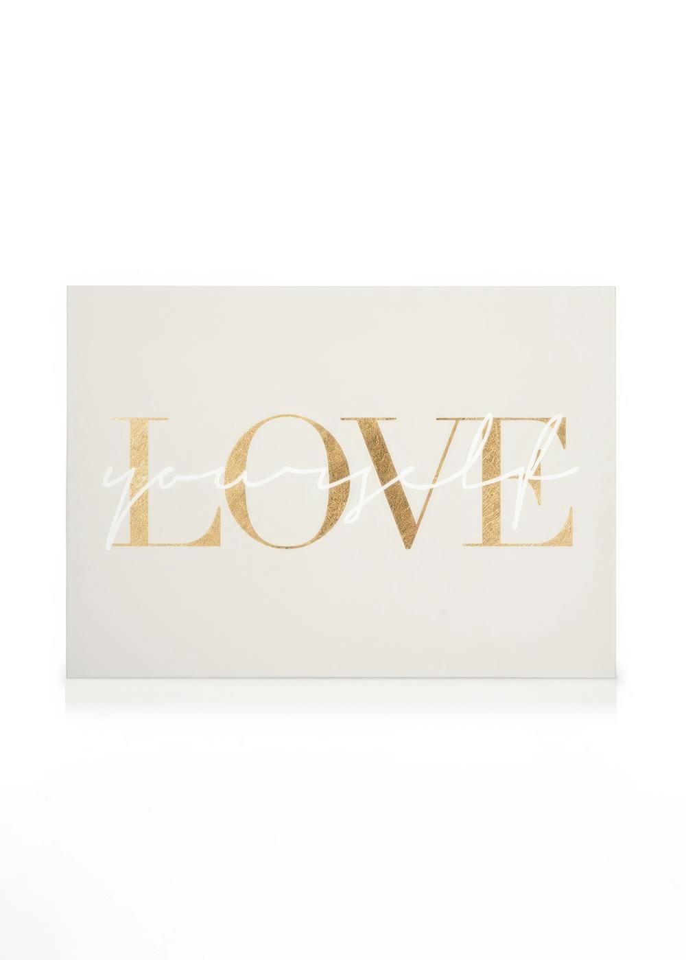 A canvas displaying the word LOVE in large metallic gold letters, with yourself in smaller white script overlaid.