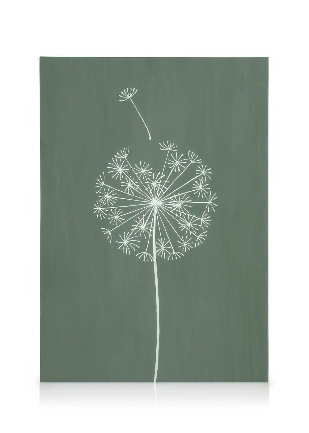 Canvas met witte paardenbloem en losvliegend zaadje op een groene achtergrond.