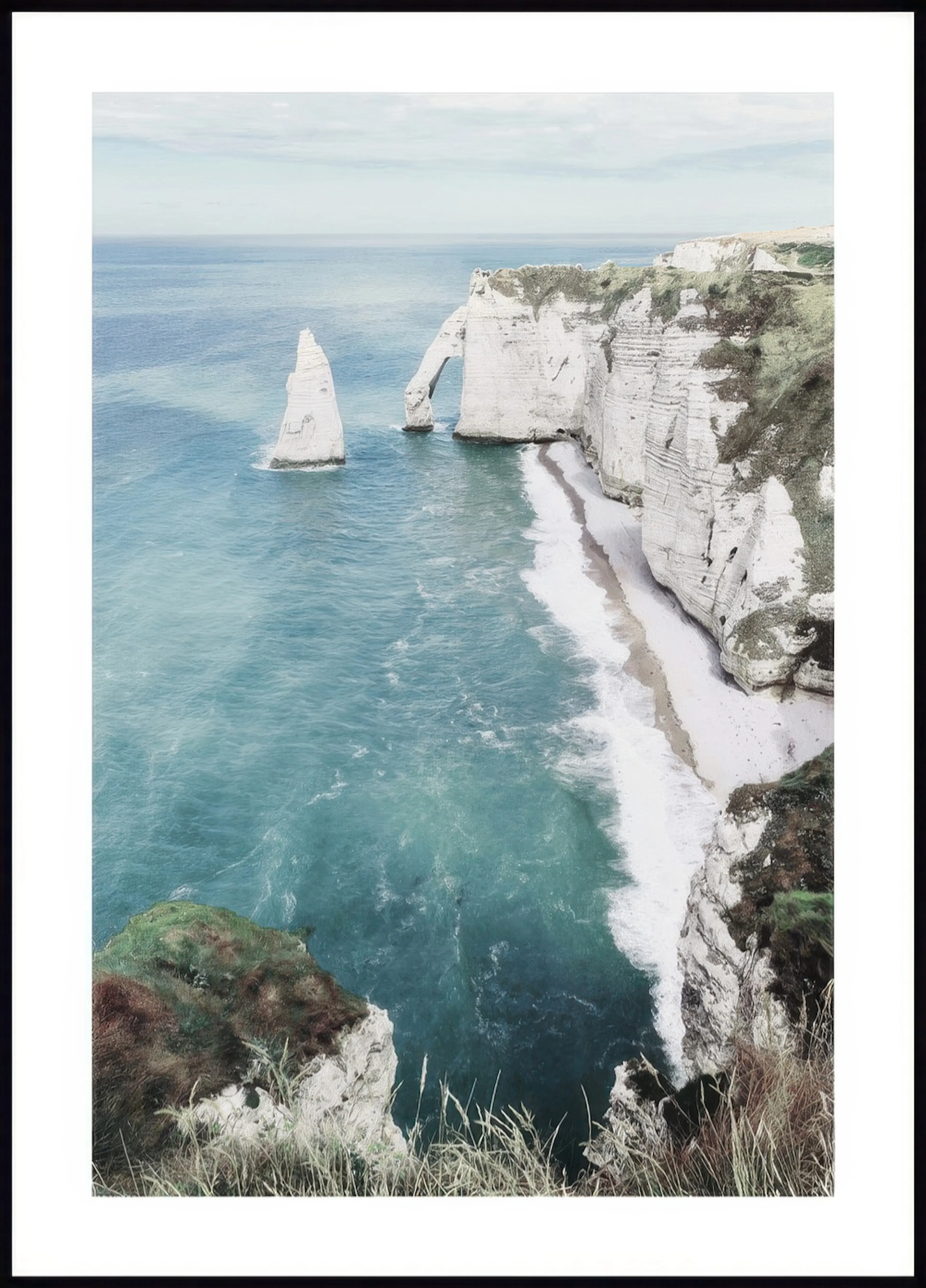 A poster featuring a dramatic coastal landscape with white chalk cliffs, a natural arch, and a sea stack in turquoise water.