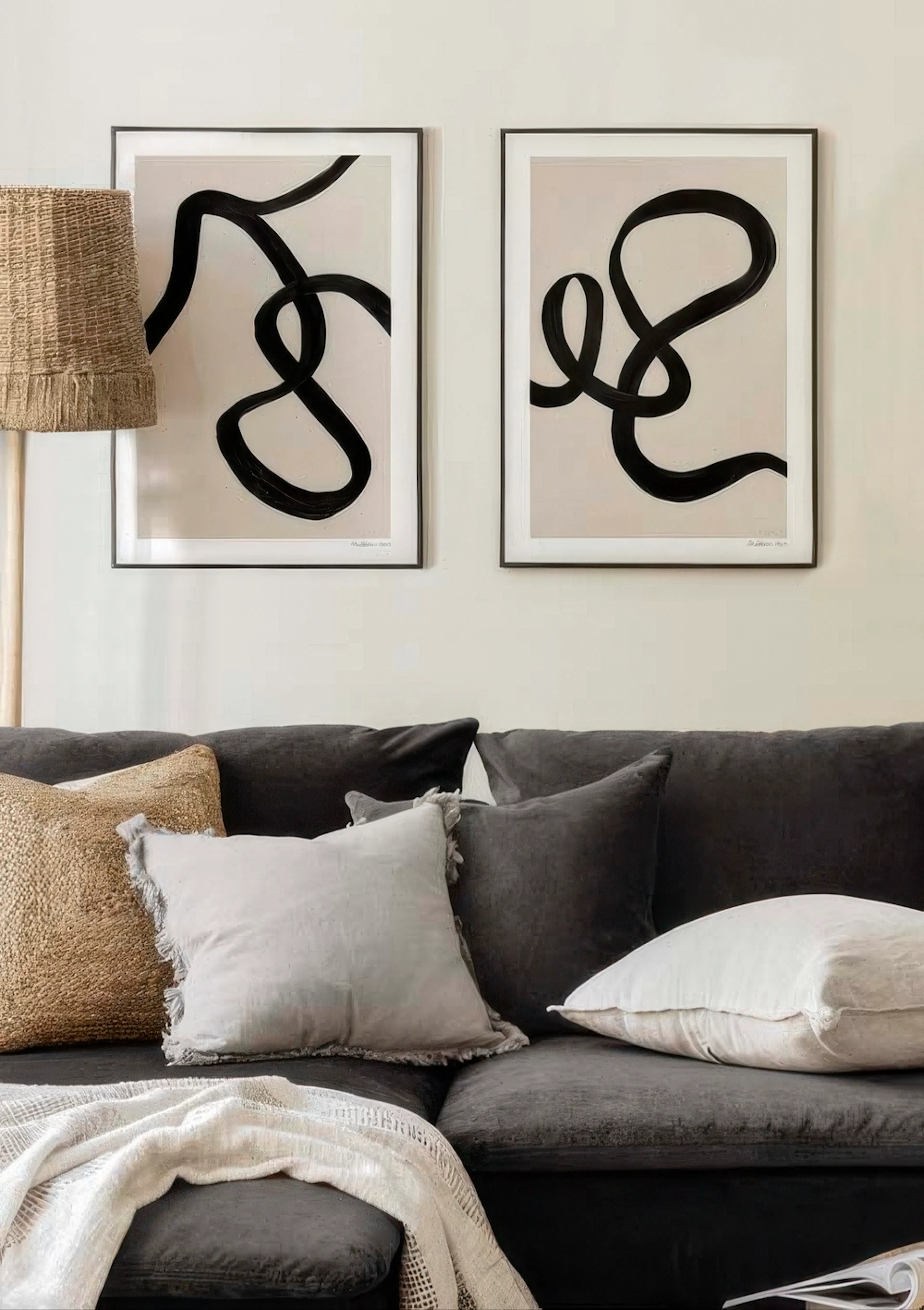A poster pack featuring two abstract prints with thick black brushstrokes forming organic shapes on a light background.