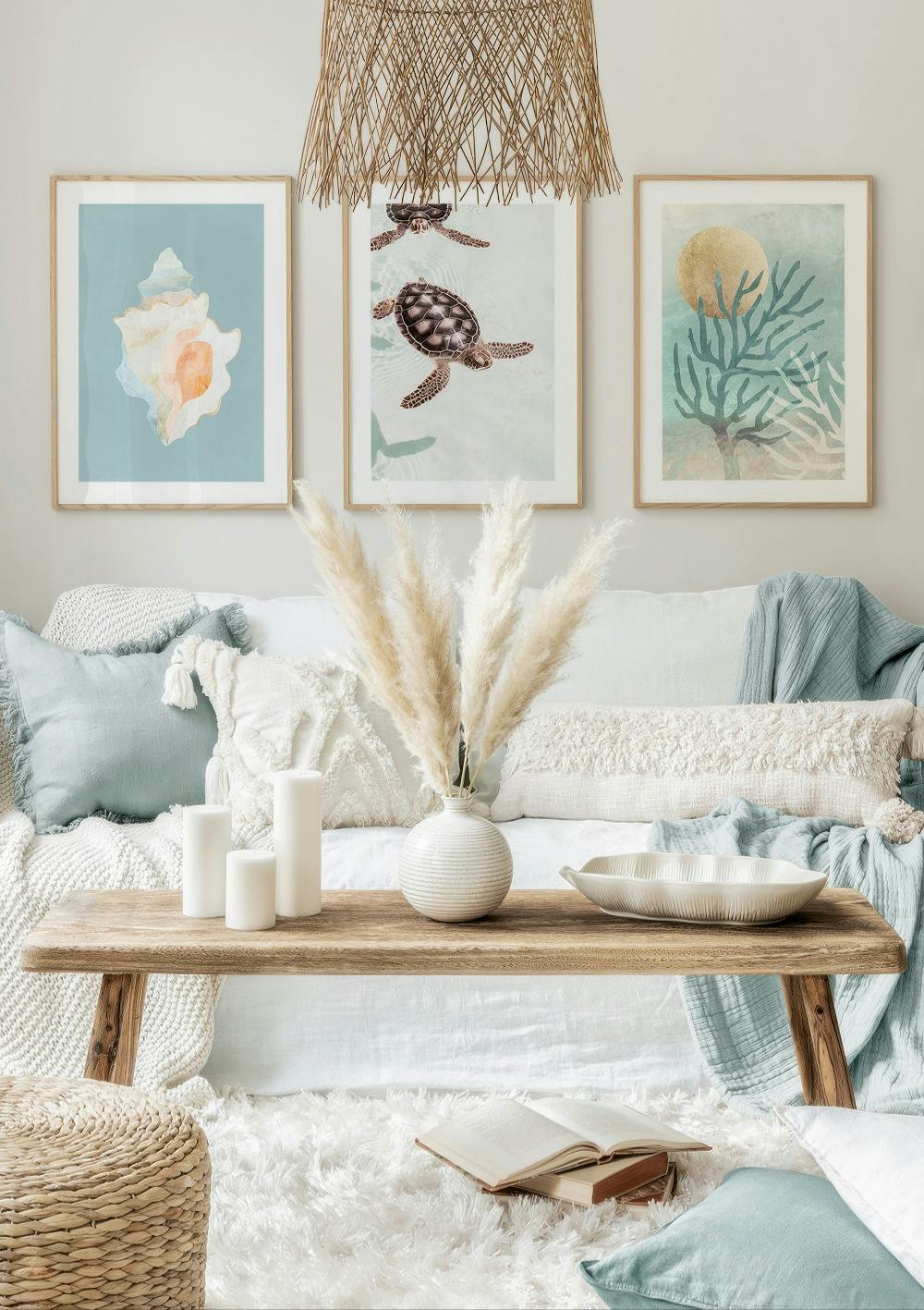 A coastal themed poster pack featuring a seashell, sea turtles, and coral reef with a golden sun, displayed in a living room.