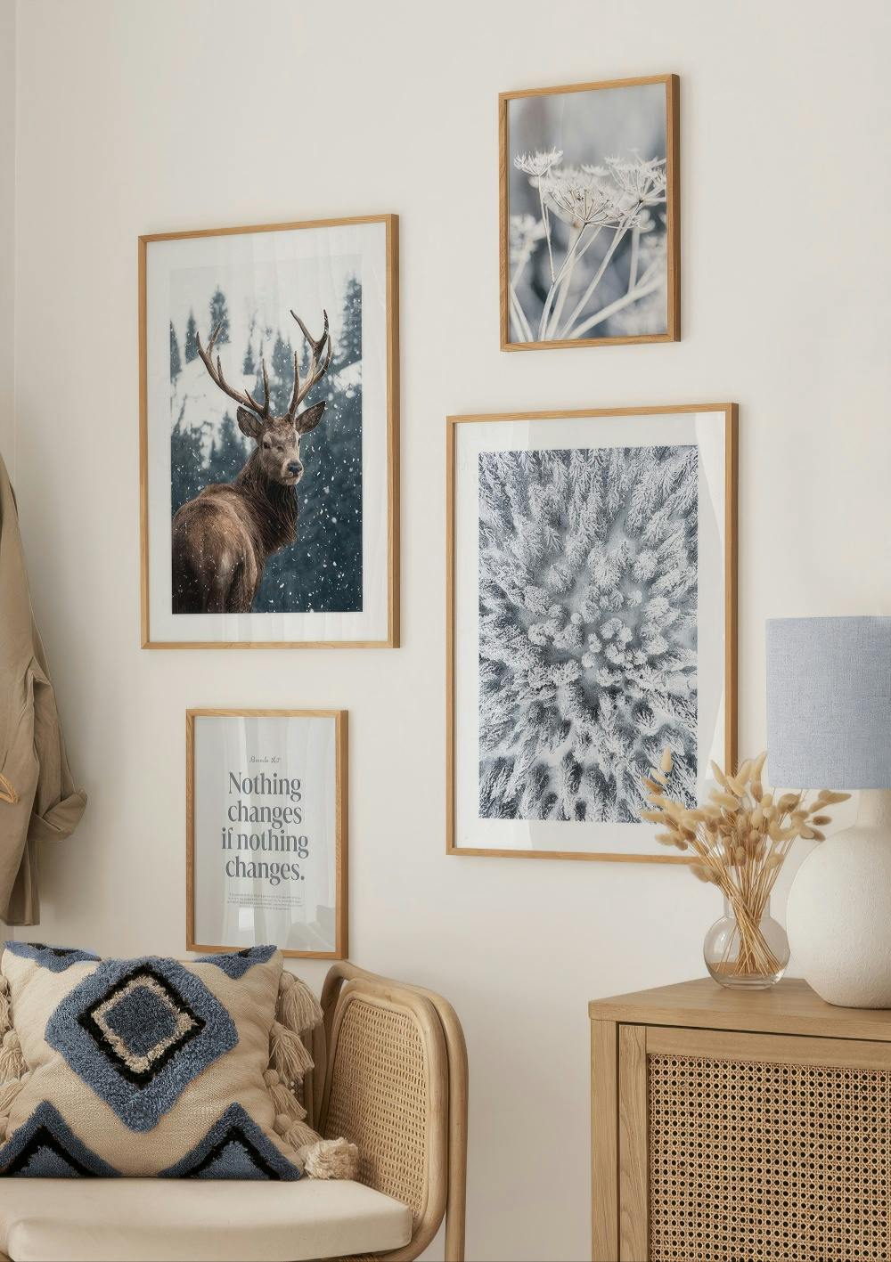 A winter-themed poster pack featuring a stag, snowy trees, and white flowers, with a text print.