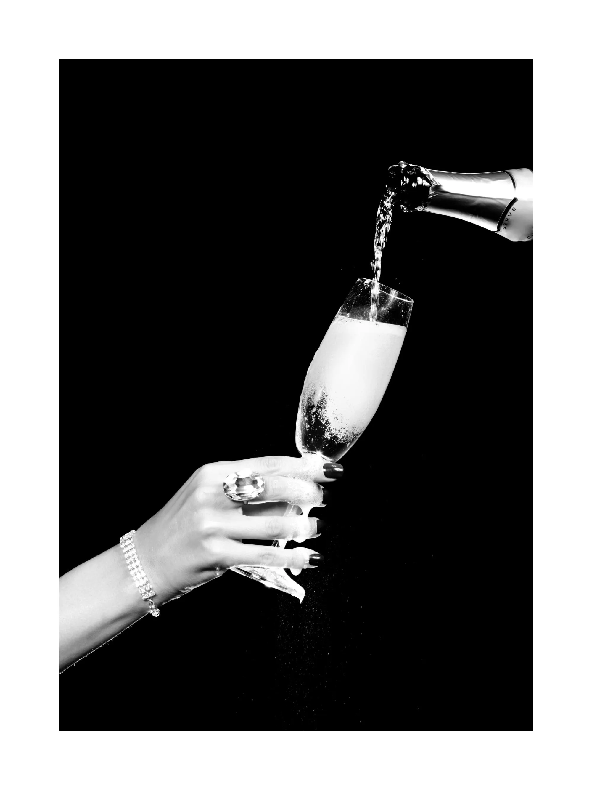 A black and white poster showing champagne pouring into a glass held by a hand with a bracelet and ring.
