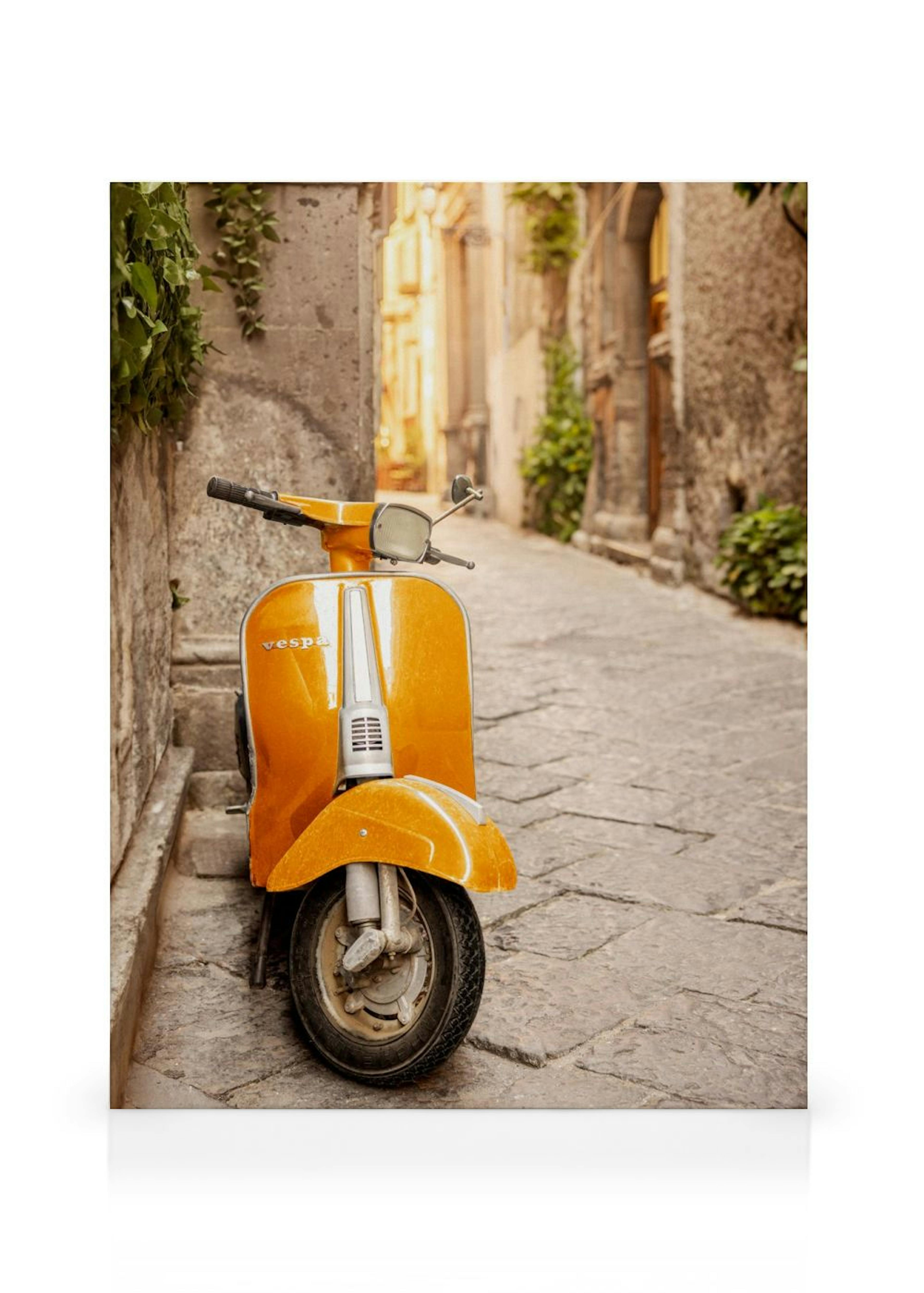 A vibrant orange Vespa scooter parked on a cobblestone street in a European alleyway, surrounded by old stone buildings.