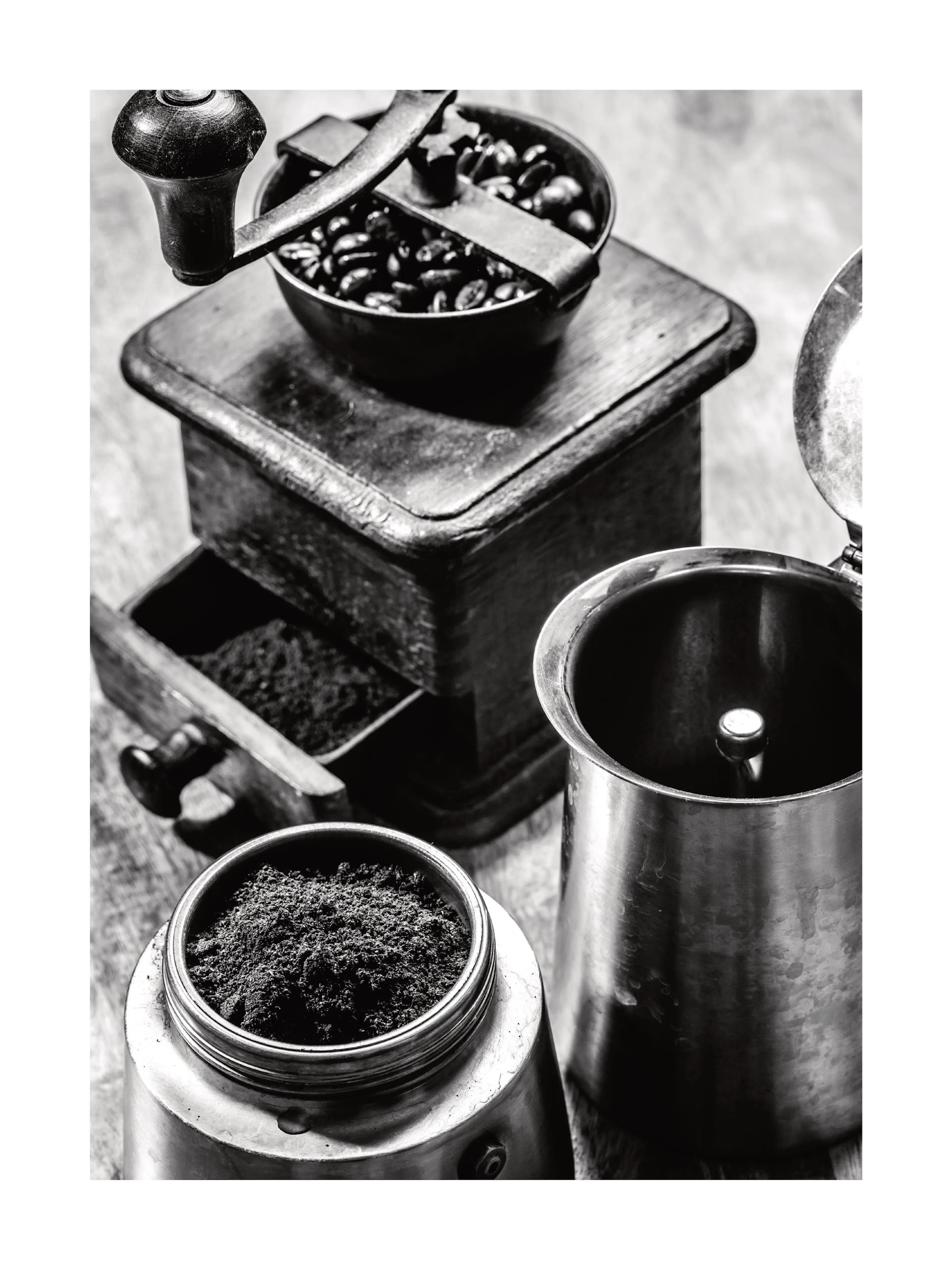 A poster of coffee beans in a grinder, fresh grounds in a drawer, and a brewing pot in black and white.