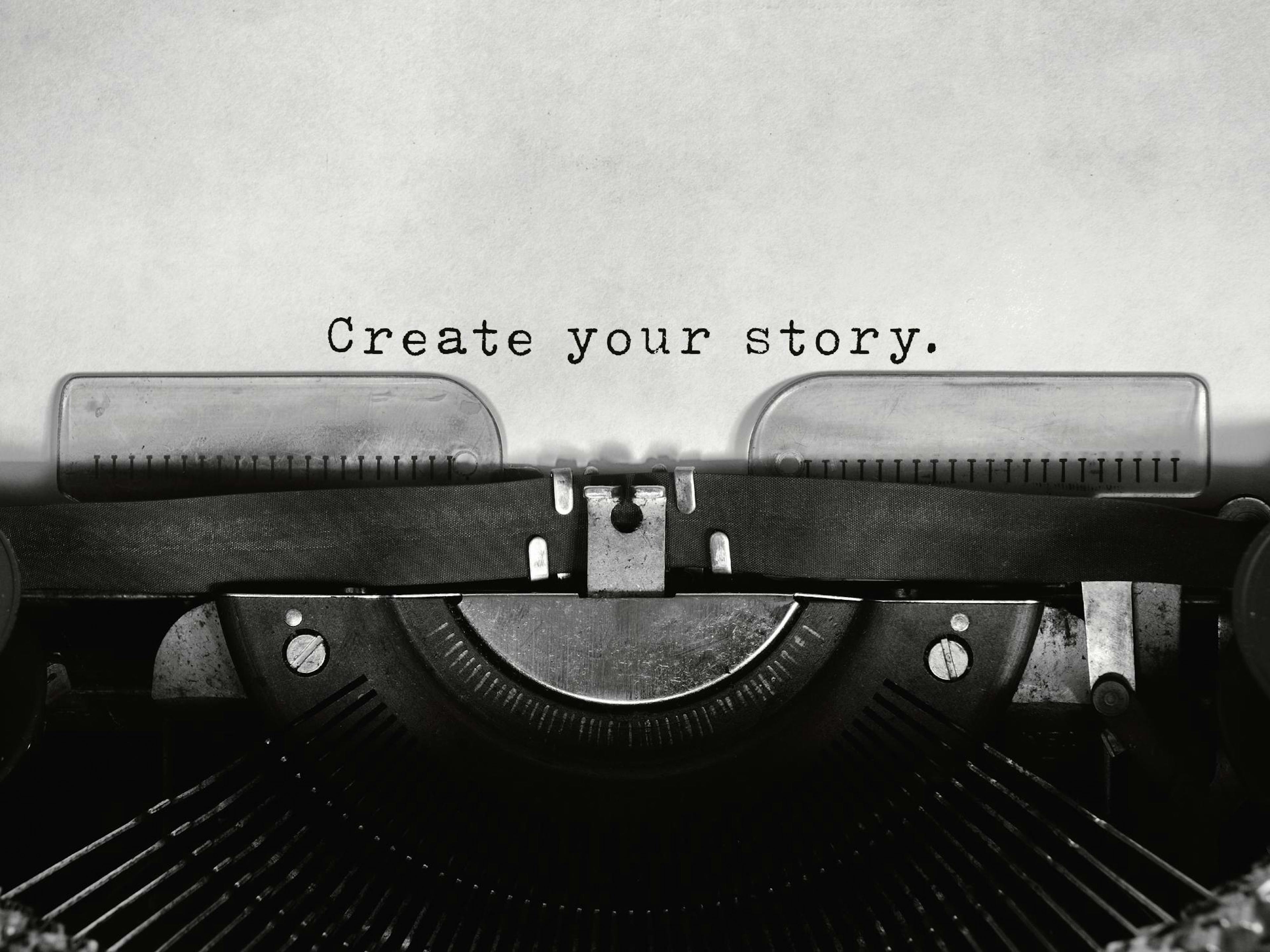 A poster featuring a vintage typewriter with the words Create your story. typed on the paper.