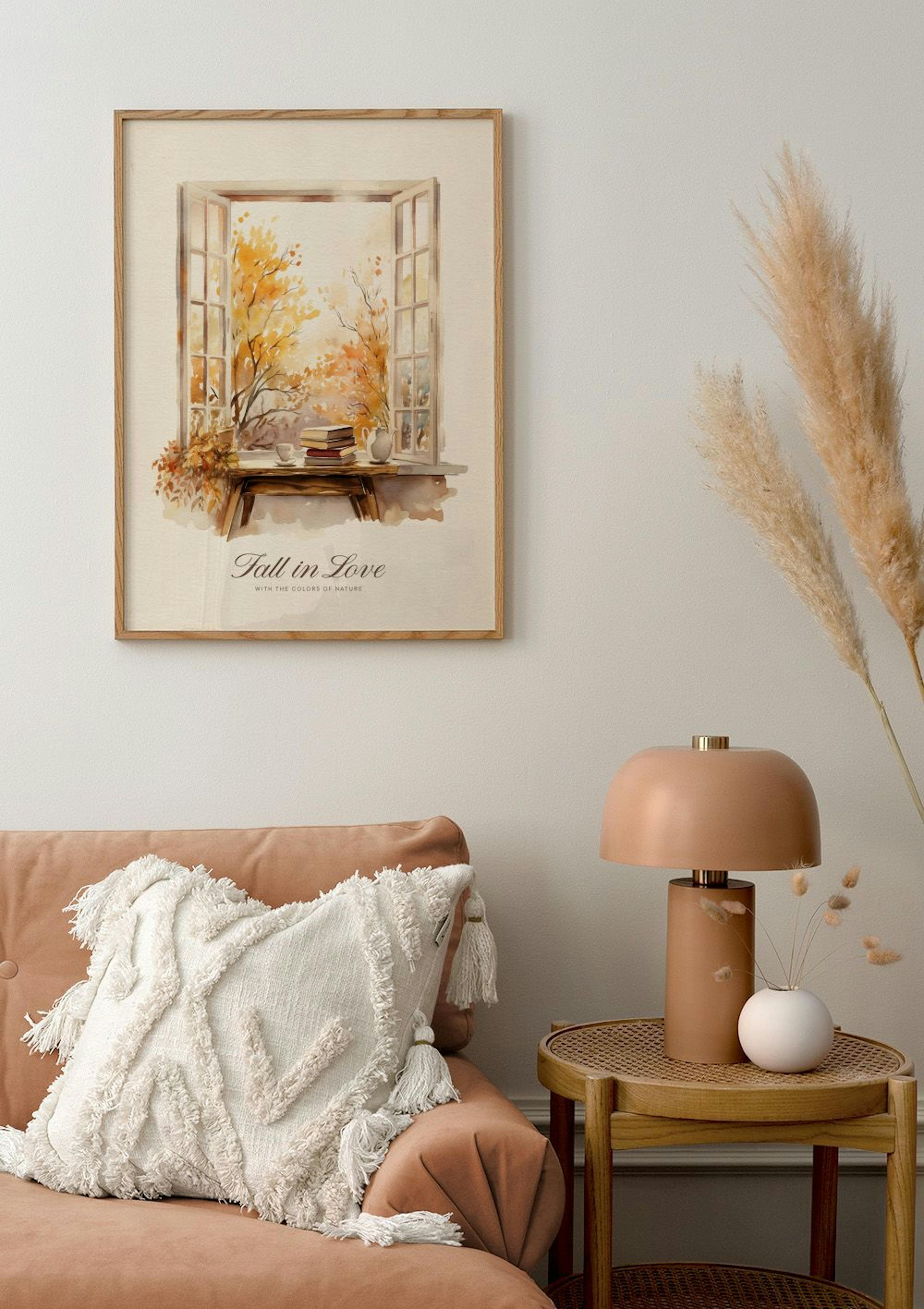 A poster of an open window with autumn trees and books, hanging above a terracotta sofa with a cushion and side table.
