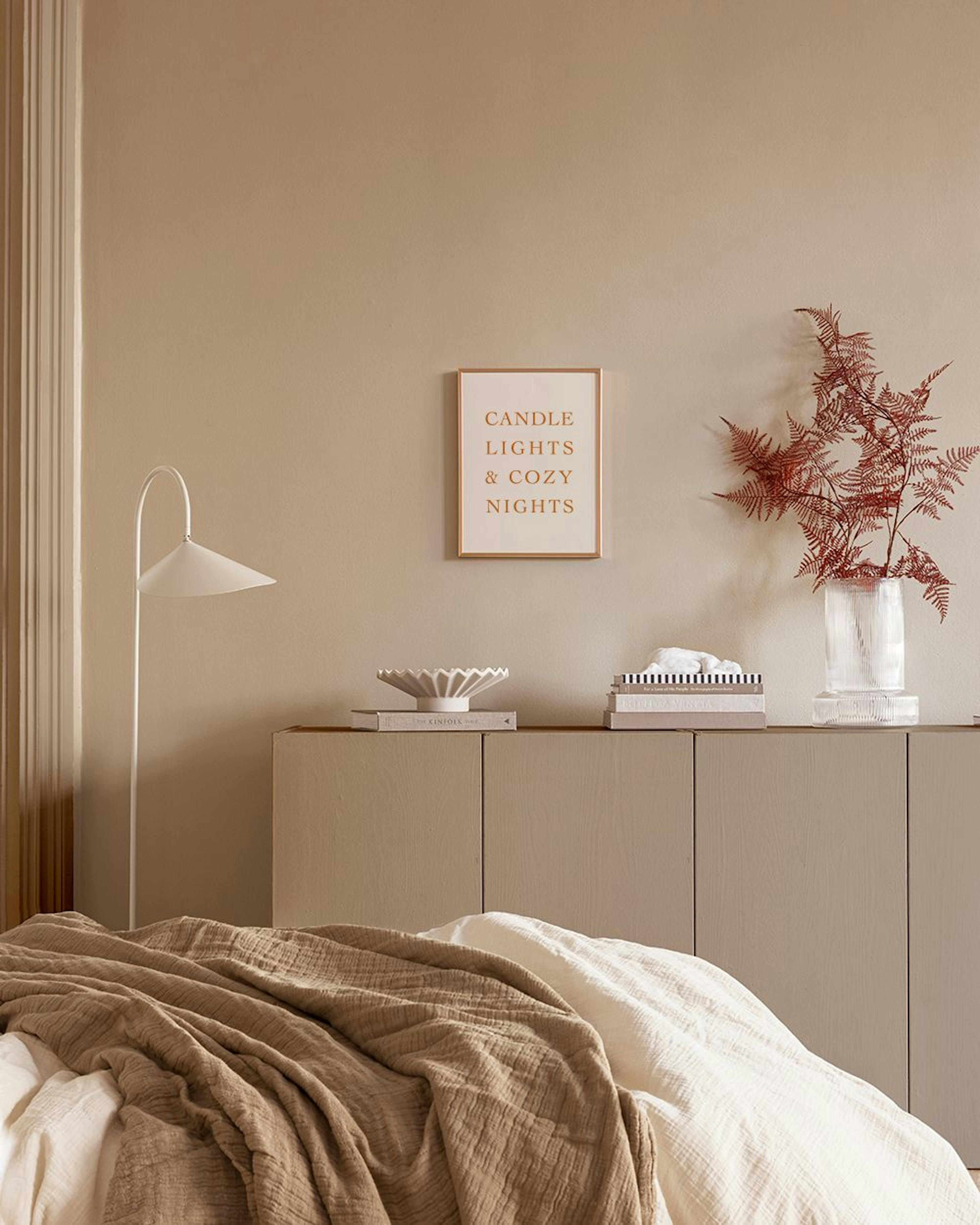 A beige poster with CANDLE LIGHTS & COZY NIGHTS in gold text, displayed in a bedroom above a cabinet.