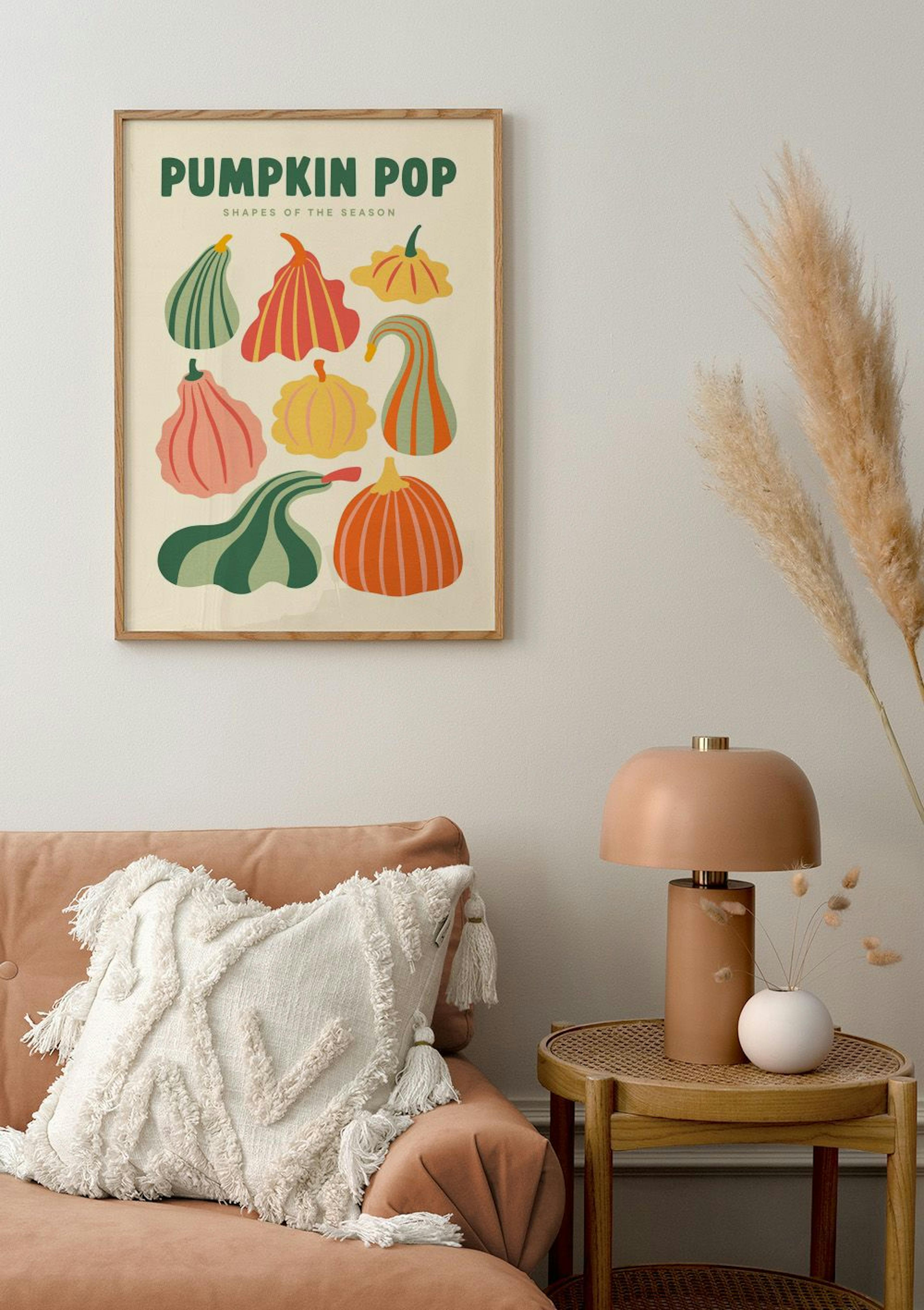 Pumpkin Pop poster with various colourful pumpkin shapes, hanging above a soft orange sofa in a modern living room.