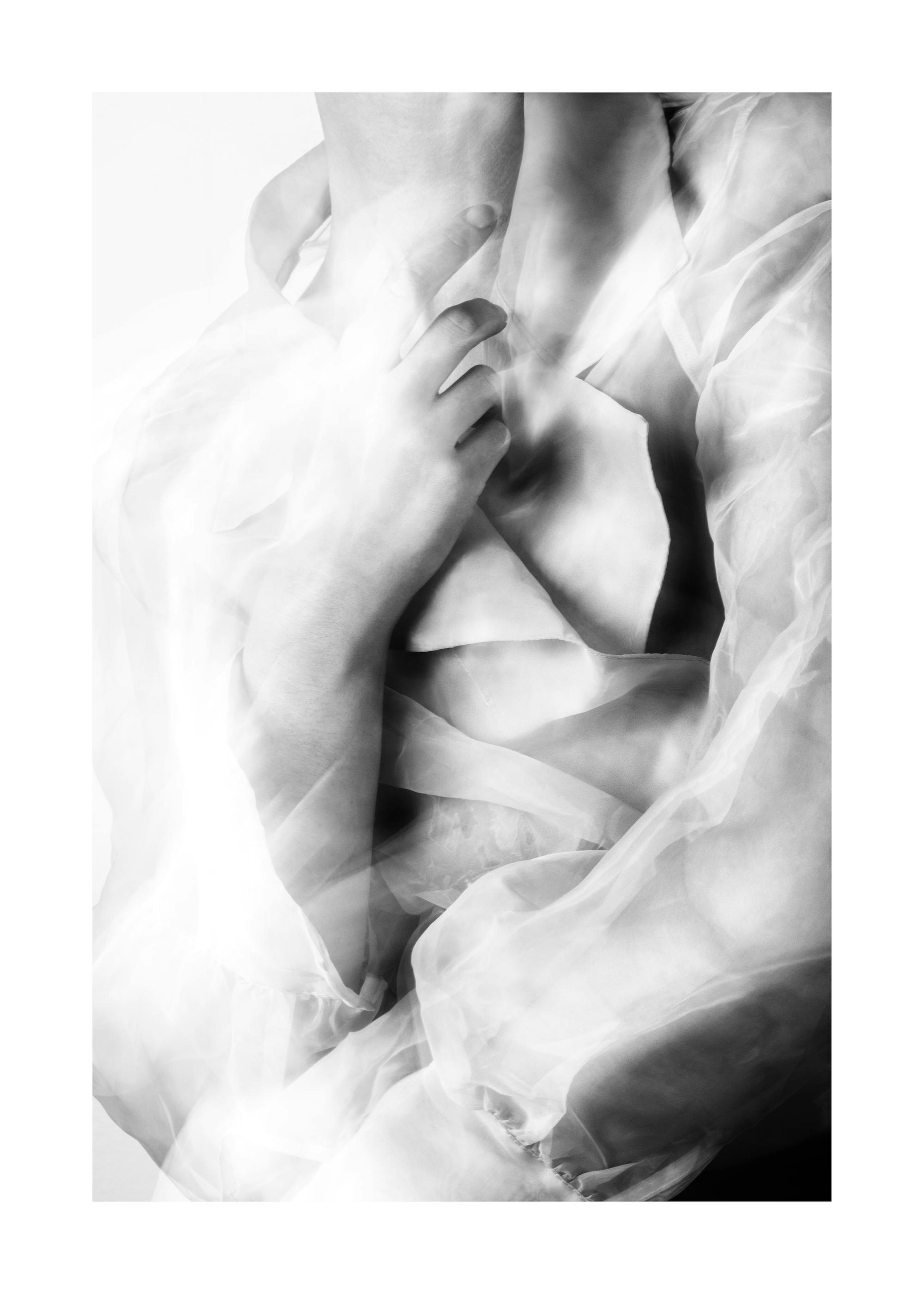 A black and white poster of a persons upper body with flowing, translucent fabric draped around them, highlighting delicate curv